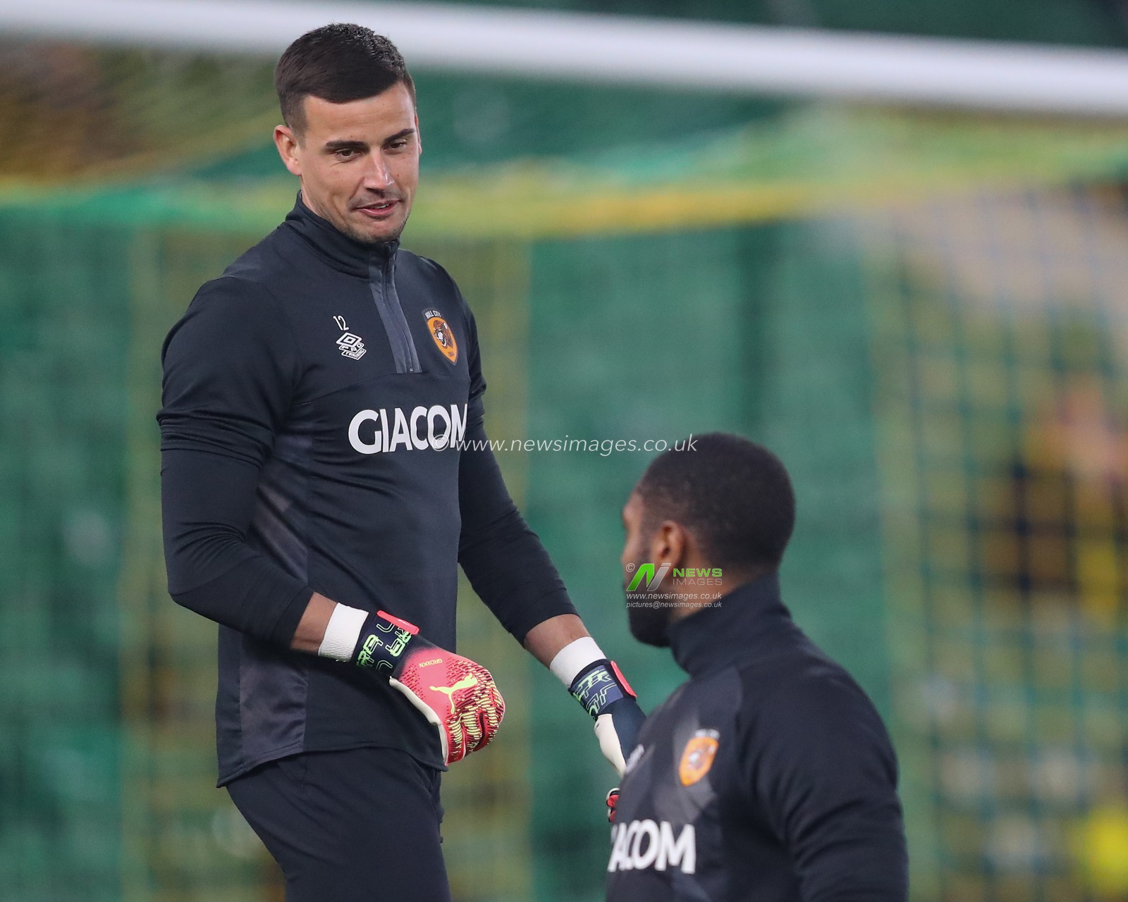 Karl Darlow #12 of Hull City talks with Thimothee Lo-Tutala #32 of Hull City during the pre-game warm up ahead of the Sky Bet Championship match Norwich City vs Hull City at Carrow Road, Norwich, United Kingdom, 14th February 2023

(Photo by Gareth Evans/News Images)