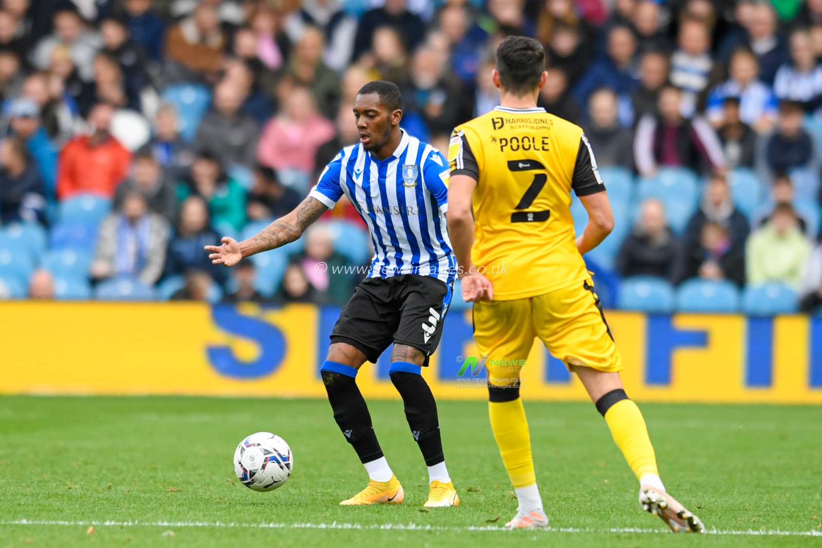 Jaden Brown #3 of Sheffield Wednesday looks for a way past Regan Poole #2 of Lincoln City