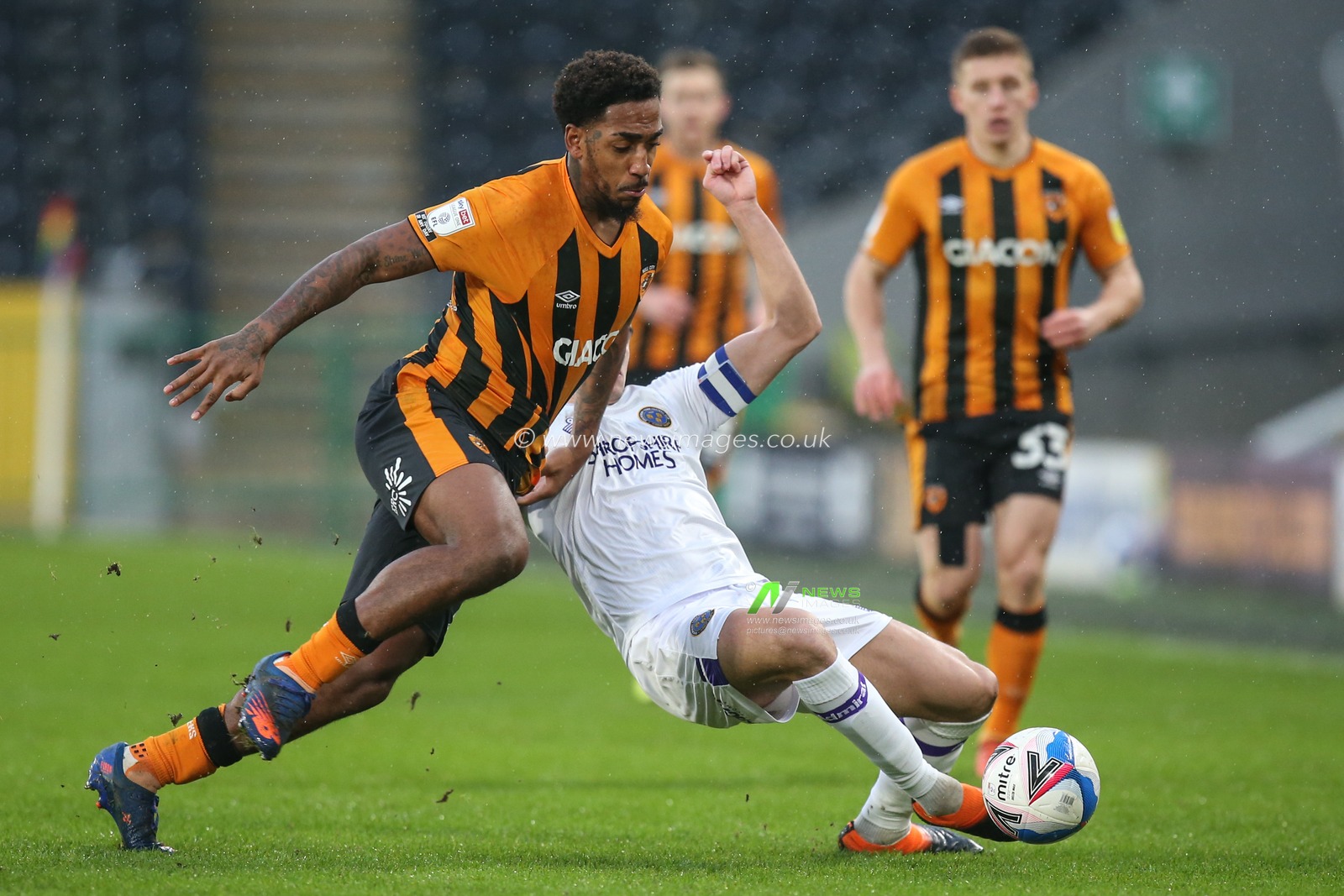 Mallik Wilks #7 of Hull City and Oliver Norburn #8 of Shrewsbury Town challenge for the ball