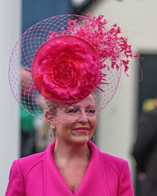 A racegoer wearing a pink dress and hat during the Randox Grand National Day 2024 at Aintree Racecourse, Liverpool, United Kingdom, 13th April 2024

(Photo by Mark Cosgrove/News Images)