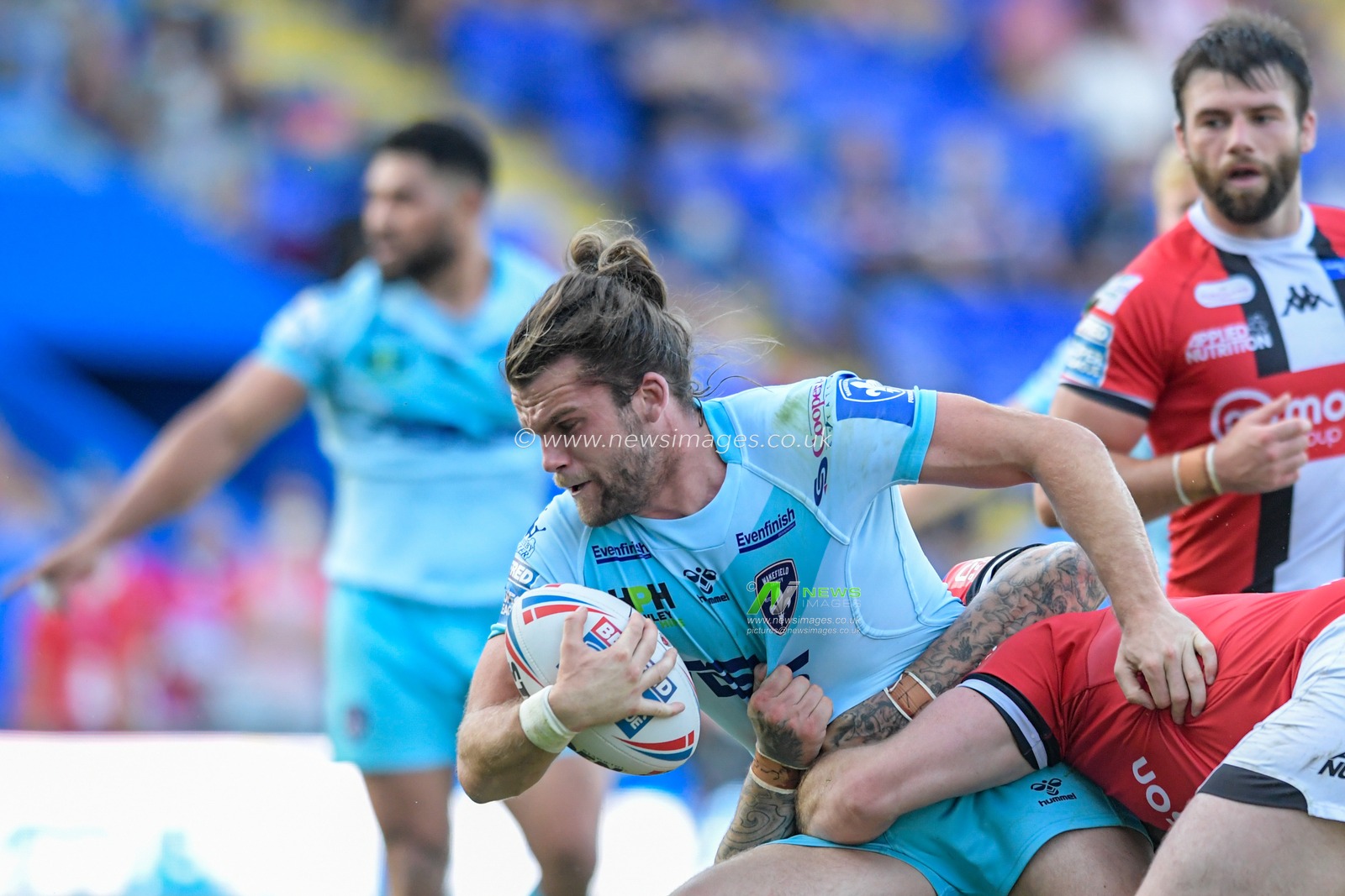 Liam Kay (5) of Wakefield Trinity attempts to break through the Salford Red Devils defensive line