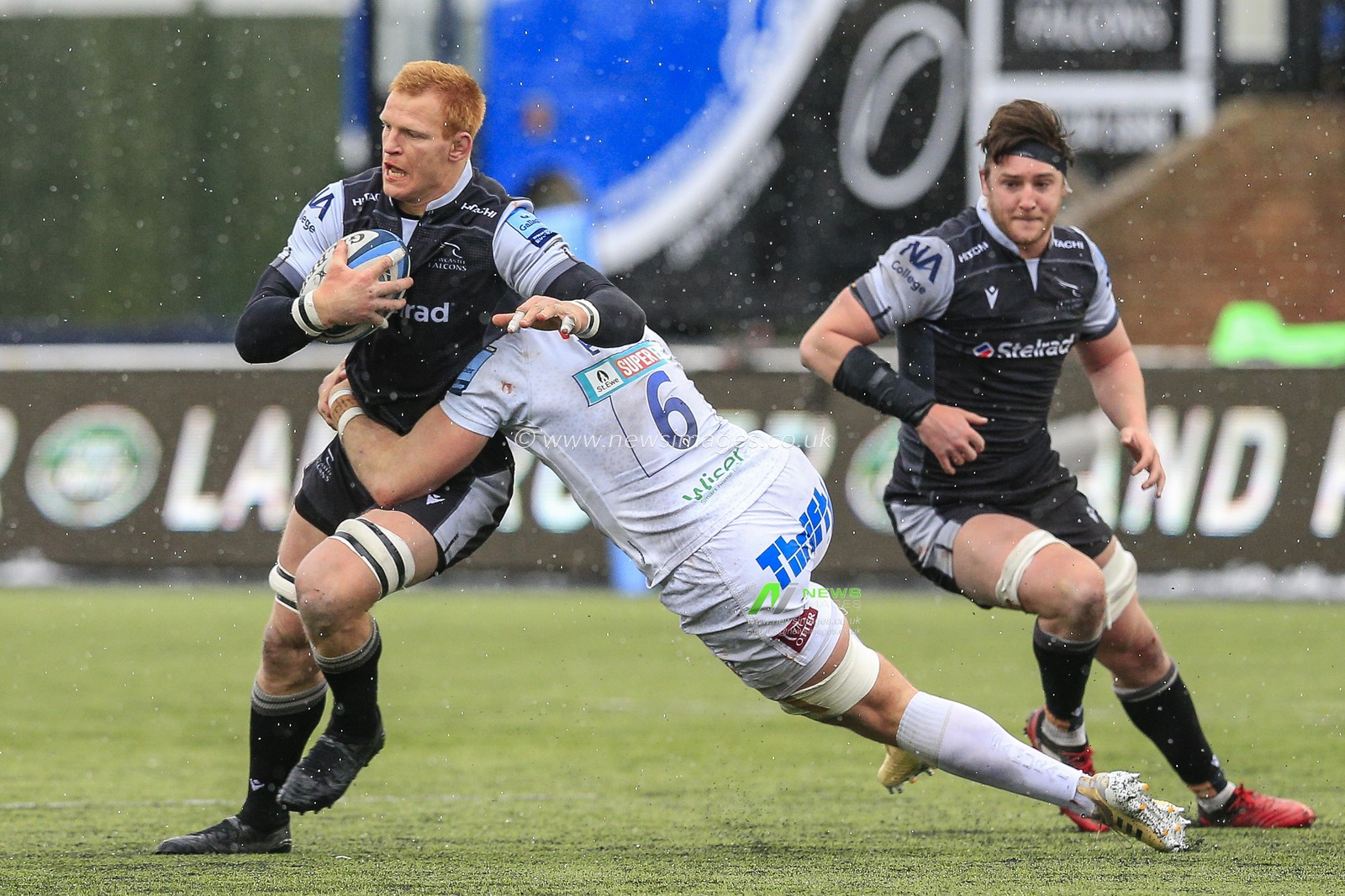 Philip van der Walt of Newcastle Falcons is tackled by Dave Ewers of Exeter Chiefs