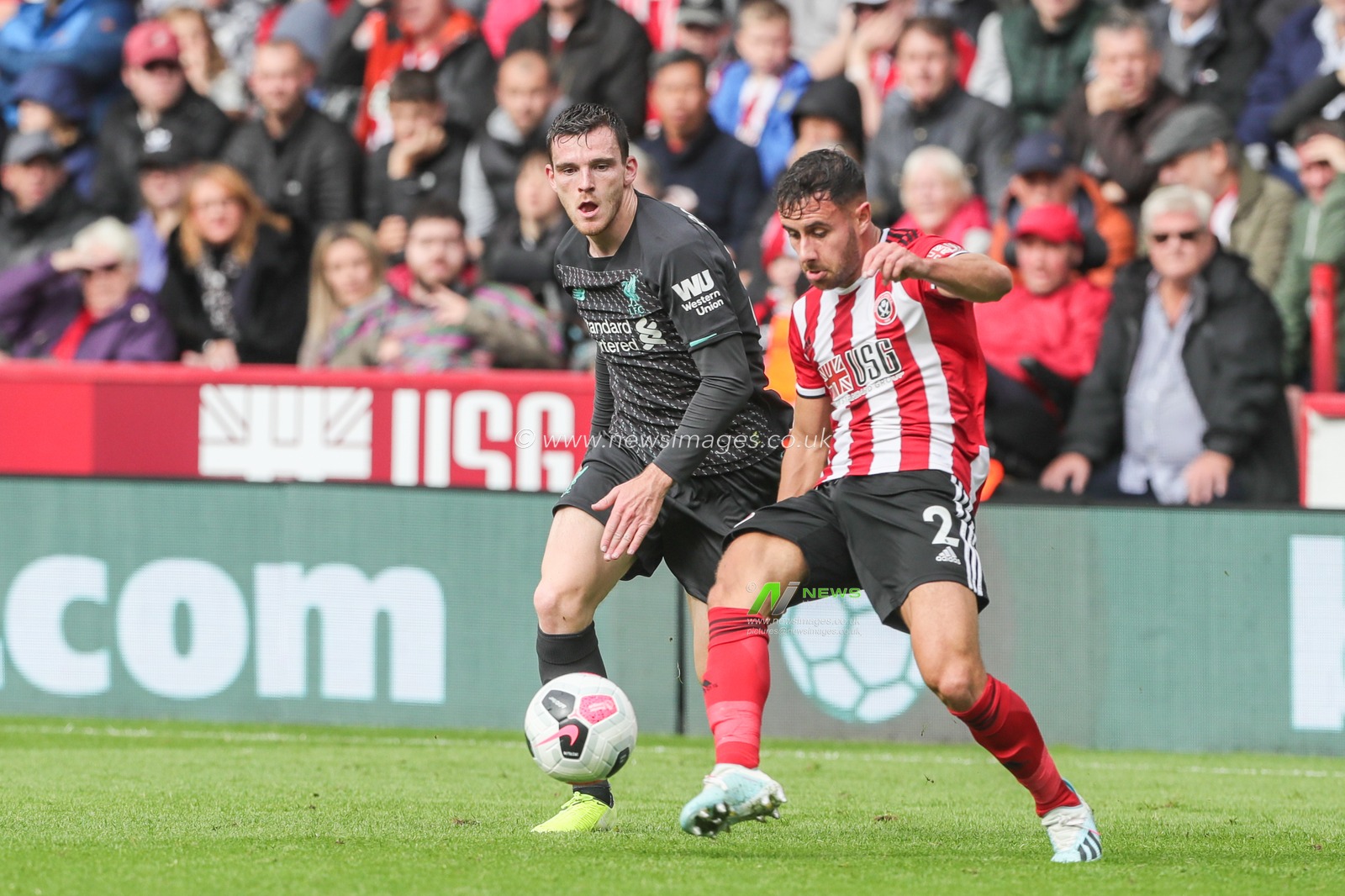 28th September 2019, Bramall Lane, Sheffield, England; Premier League, Sheffield United v Liverpool : George Baldock (2) of Sheffield United clears the ball from Andrew Robertson (26) of Liverpool 

Credit: Mark Cosgrove/News Images