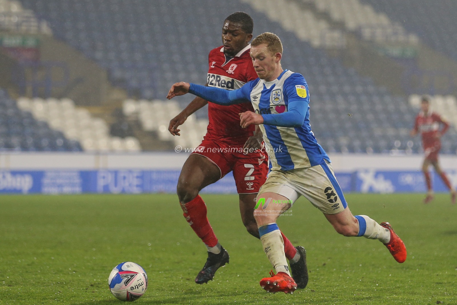 Lewis Oâ€™Brien #8 of Huddersfield Town takes on Anfernee Dijksteel #2 of Middlesbrough