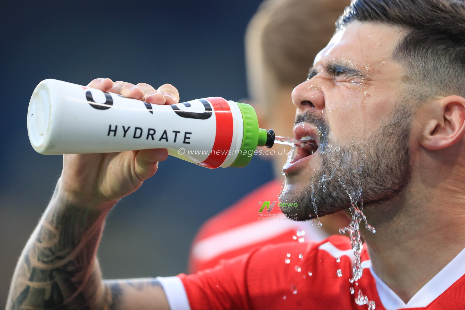 Alex Mowatt #27 of Barnsley takes on water