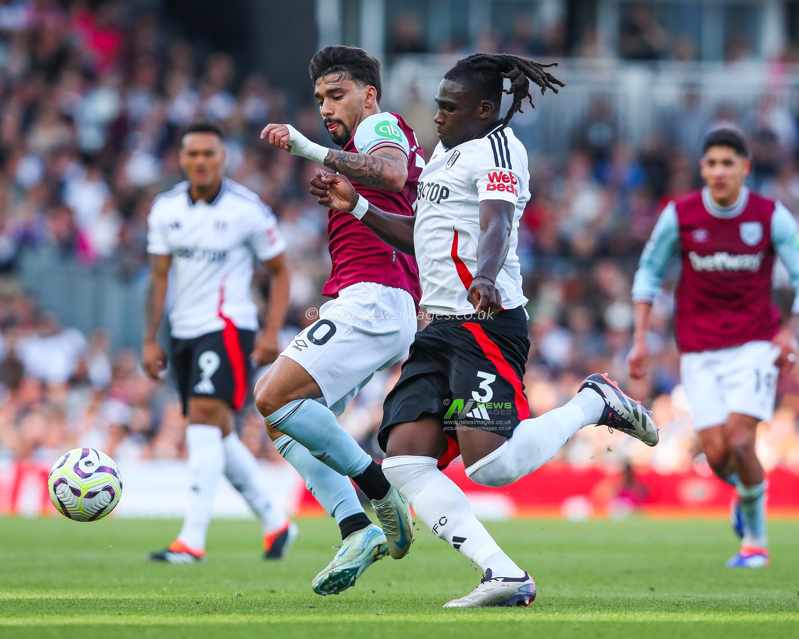 Lucas Paqueta of West Ham United is put under pressure by Calvin Bassey of Fulham during the Premier League match Fulham vs West Ham United at Craven Cottage, London, United Kingdom, 14th September 2024

(Photo by Izzy Poles/News Images)
