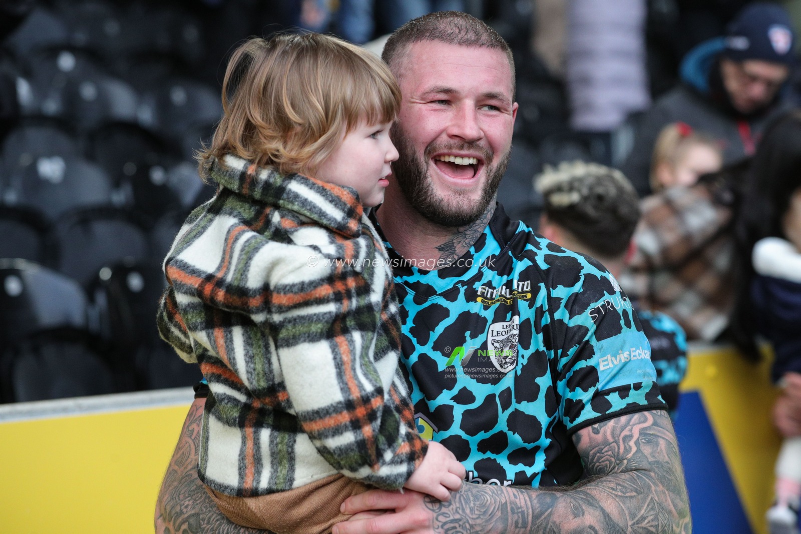 Zak Hardaker #1 of Leigh Leopards celebrates the win with his daughter and the travelling supporters after the Betfred Super League  Round 6 match Hull FC vs Leigh Leopards at MKM Stadium, Hull, United Kingdom, 25th March 2023

(Photo by James Heaton/News Images)