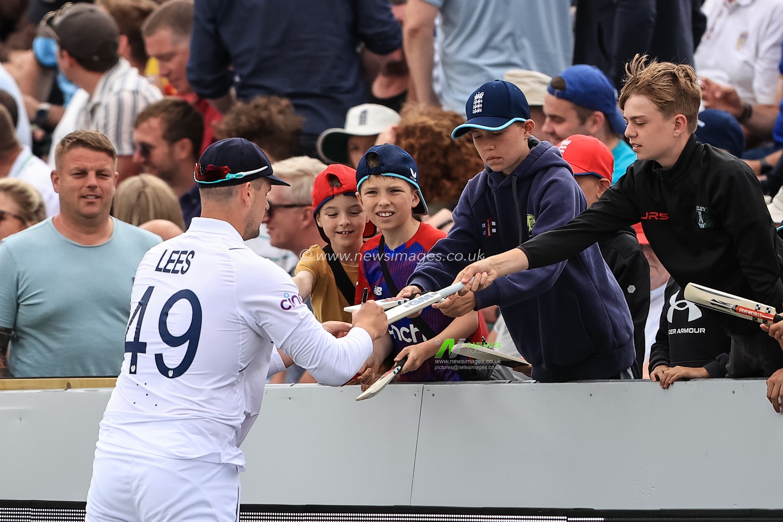 Alex Lees of England signs a young England fans mini bat