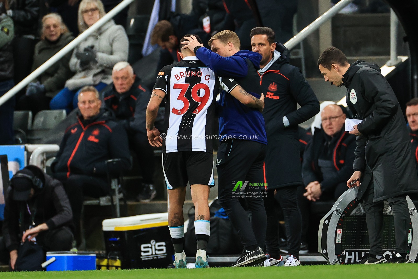 Eddie Howe manager of Newcastle United pats Bruno Guimaraes #39 on the head as he leaves the field