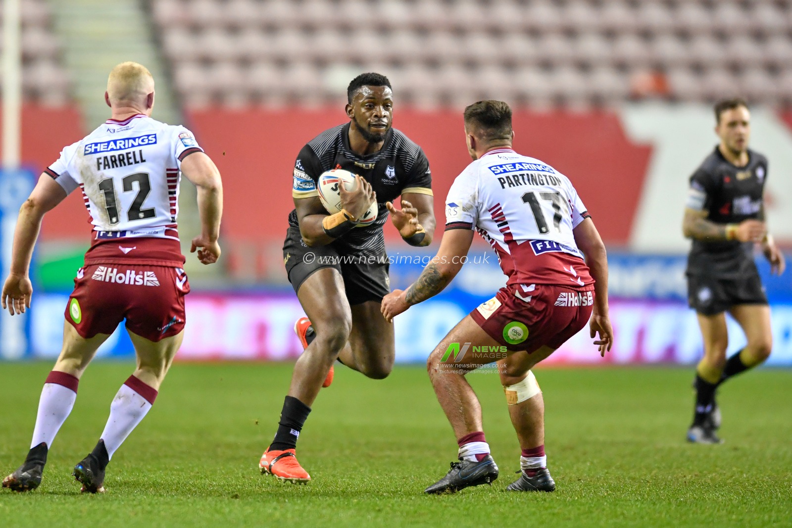 13th February 2020, DW Stadium, Wigan, England; Betfred Super League, Wigan Warriors v Toronto Wolfpack : Gadwin Springer (15) of Toronto Wolfpack runs at the Wigan Warriors defensive line