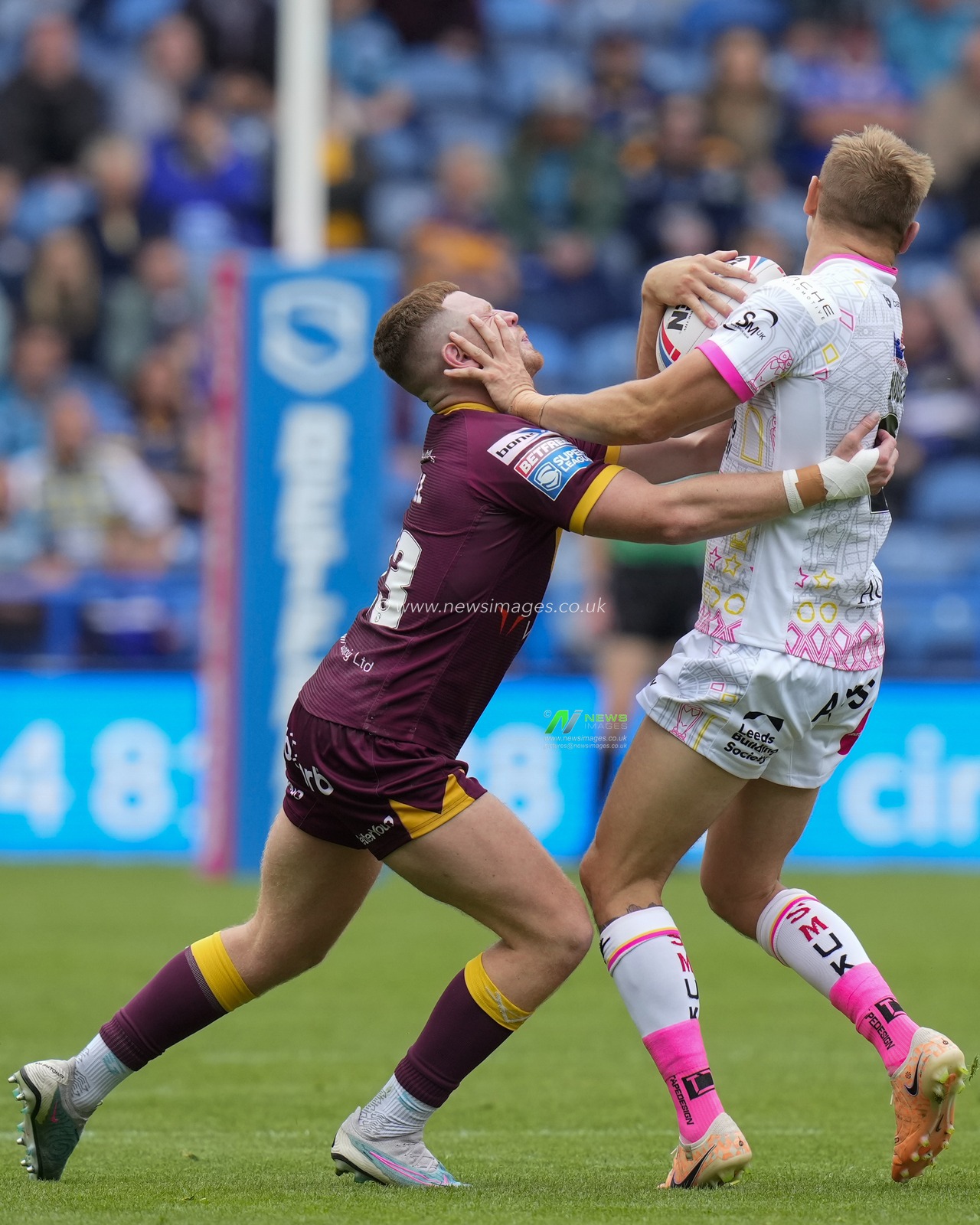Luke Hooley #21 of Leeds Rhinos hands off Olly Russell #23 of Huddersfield Giants during the Betfred Super League Round 23 match Huddersfield Giants vs Leeds Rhinos at John Smith's Stadium, Huddersfield, United Kingdom, 27th August 2023

(Photo by Steve Flynn/News Images)