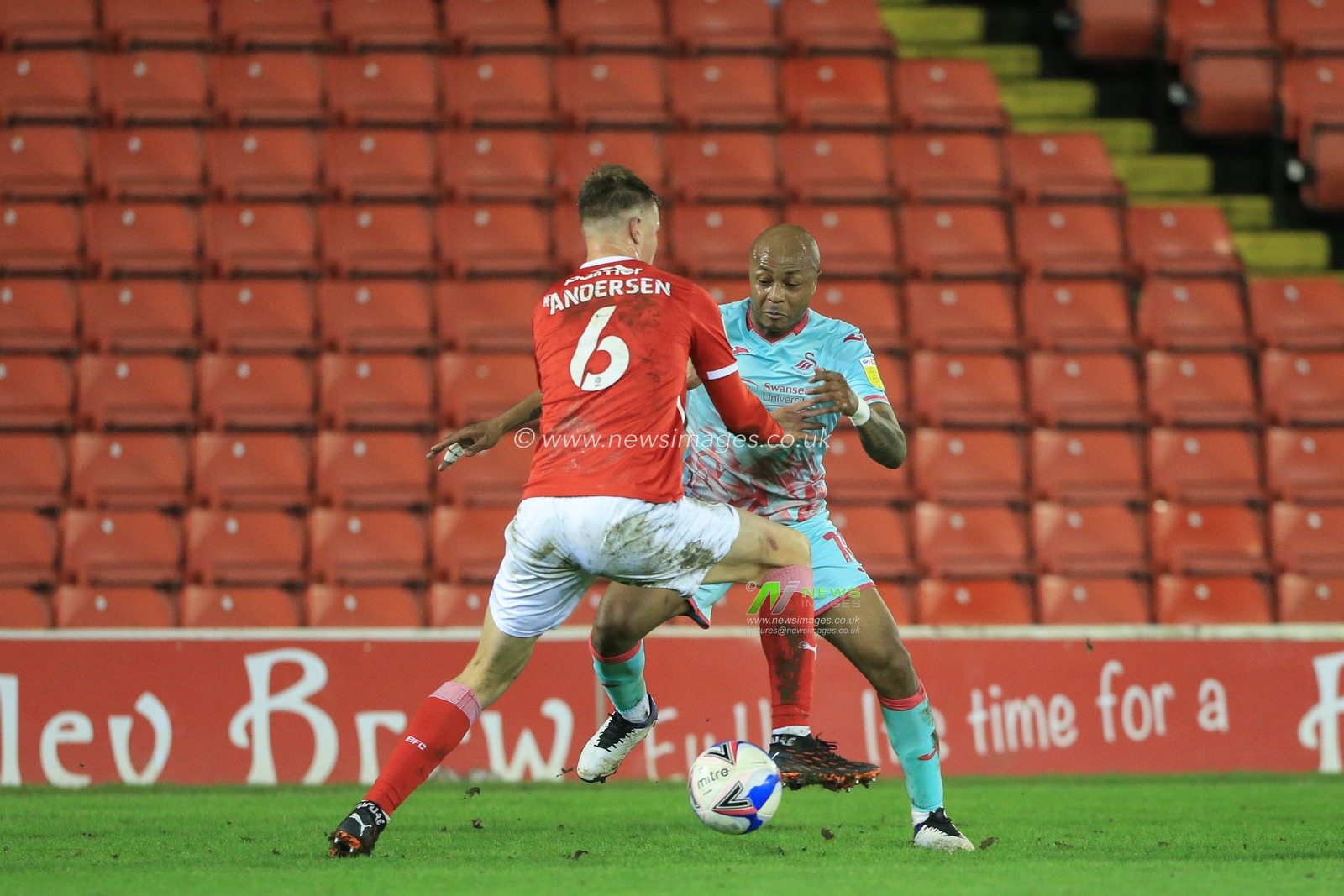 Andre Ayew #10 of Swansea City , Herbie Kane contest the ball