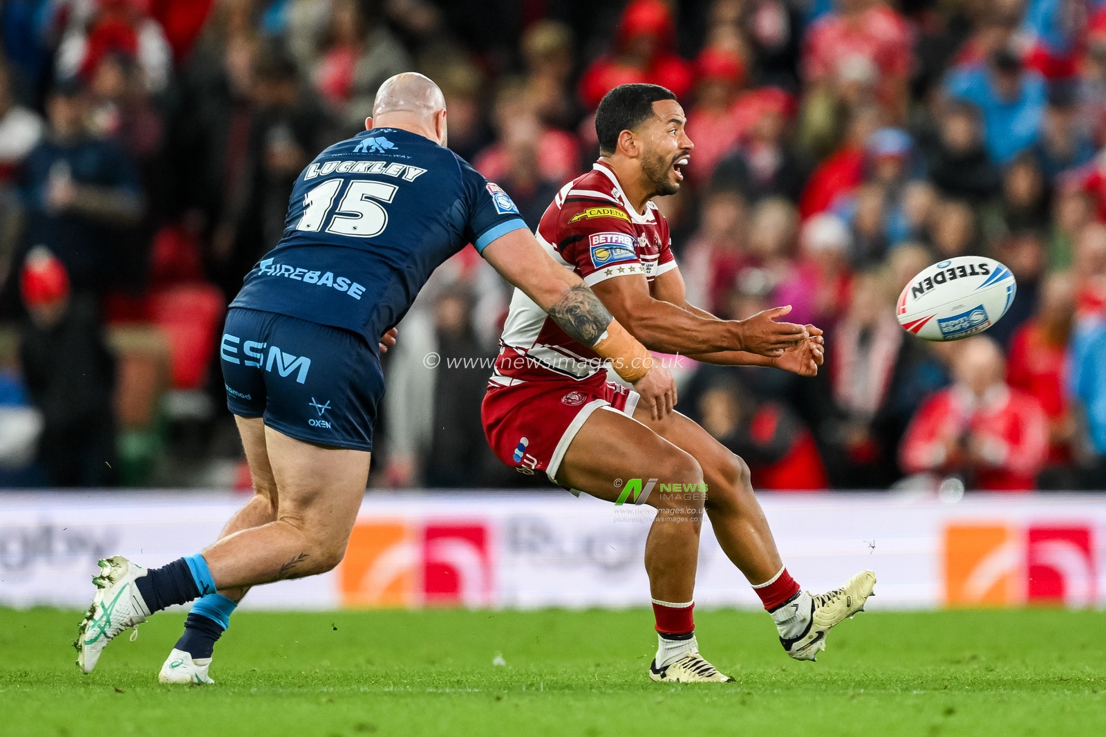 Kruise Leeming of Wigan Warriors offloads the ball during the Betfred Super League Grand Final match Wigan Warriors vs Hull KR at Old Trafford, Manchester, United Kingdom, 12th October 2024

(Photo by Craig Thomas/News Images)