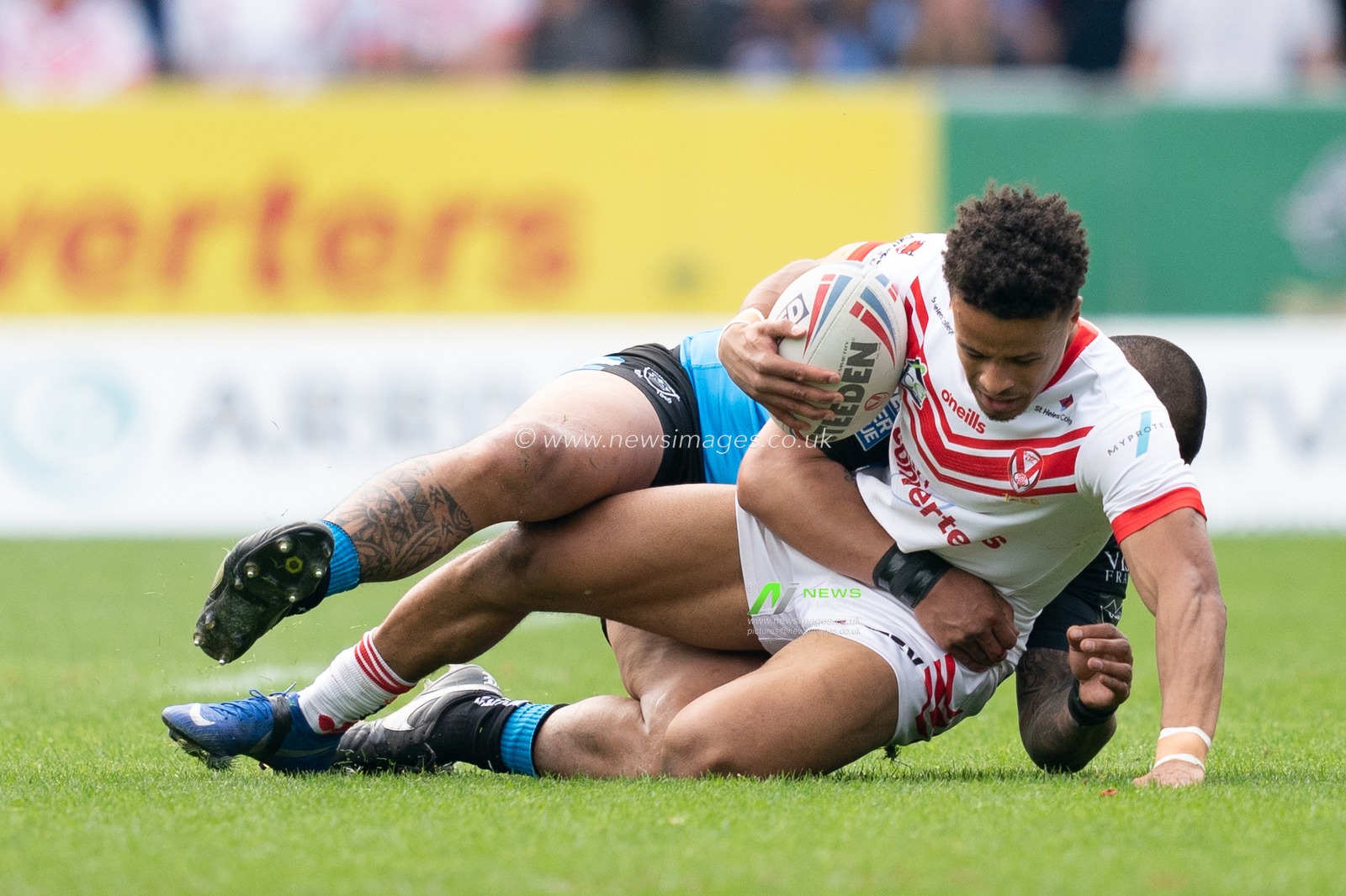 St. Helens's Regan Grace is tackled
22nd April 2019 , Totally Wicked Stadium, St Helens, England;  Betfred Super League, Round 12, St Helens vs Hull FC

Credit: Terry Donnelly/News Images