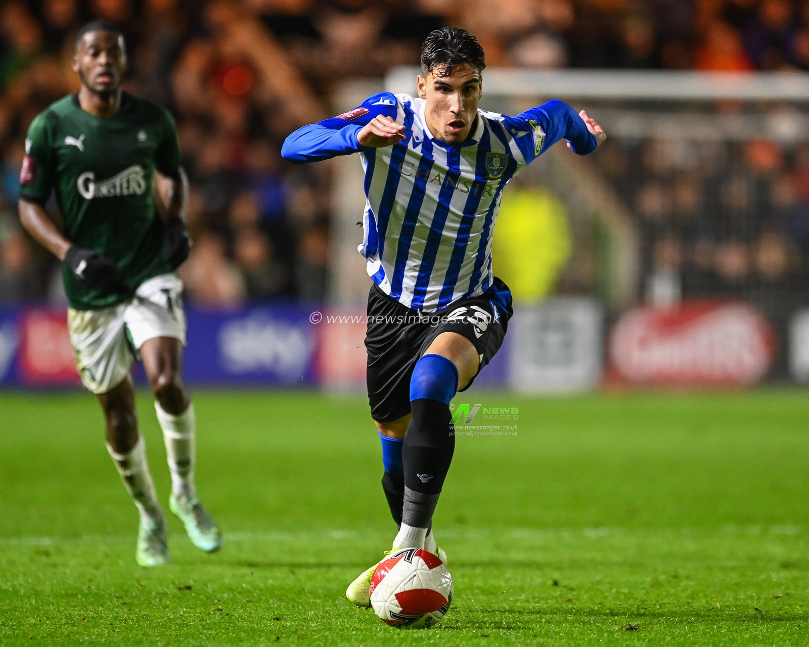 Theo Corbeanu #23 of Sheffield Wednesday makes a break with the ball