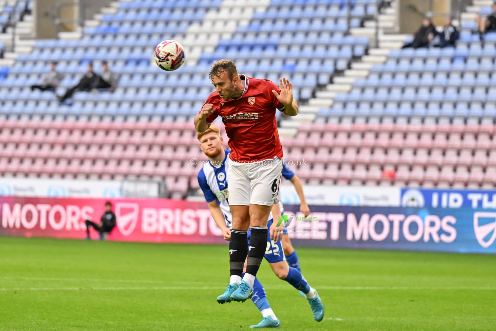 Jamie Stott of Morecambe heads the ball during the Bristol Street Motors Trophy match Wigan Athletic vs Morecambe at DW Stadium, Wigan, United Kingdom, 3rd September 2024

(Photo by Cody Froggatt/News Images)