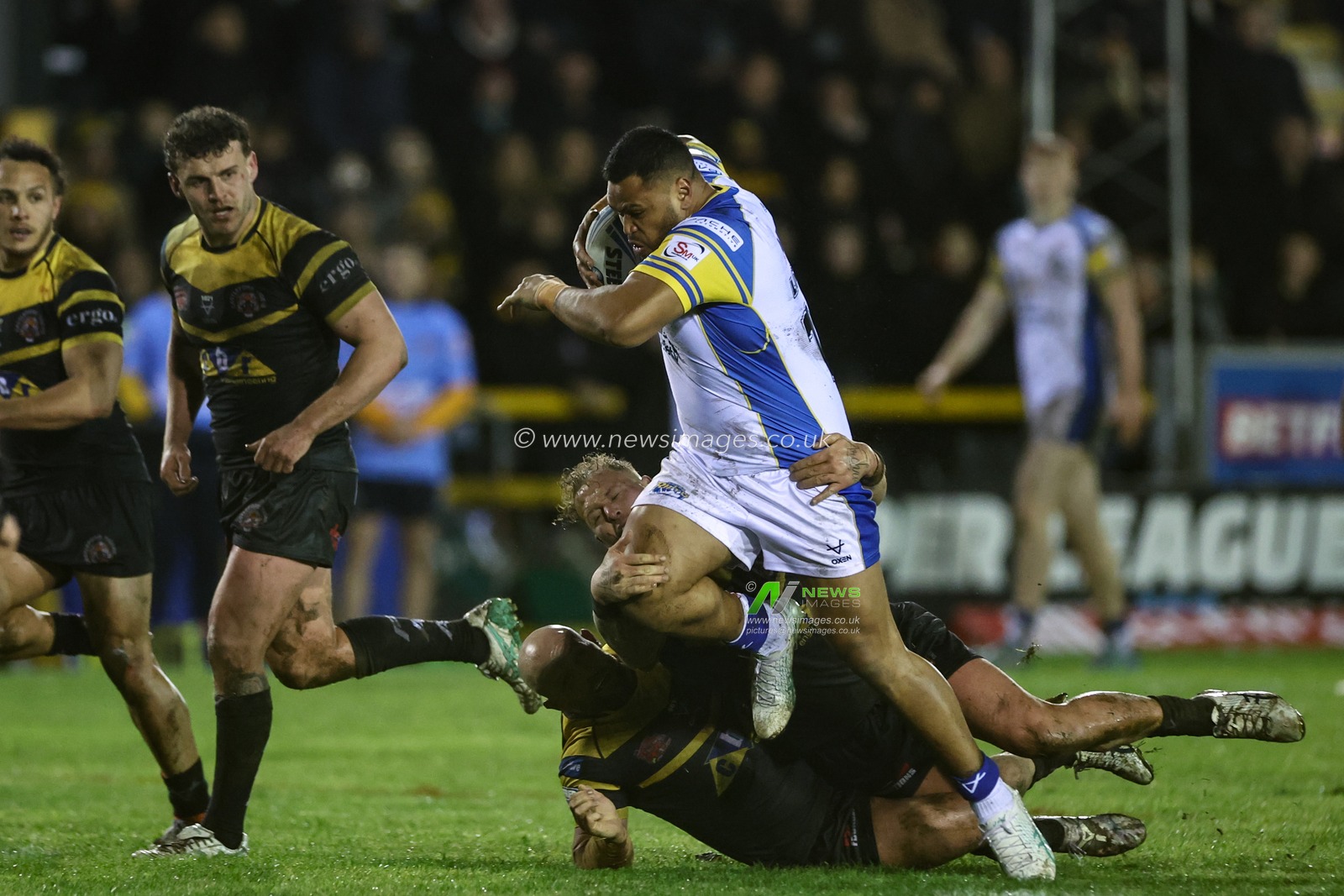 Sam Lisone of Leeds Rhinos powers past Paul McShane of Castleford Tigers and Joe Westerman of Castleford Tigers during the Betfred Super League Round 6 match Castleford Tigers vs Leeds Rhinos at The Mend-A-Hose Jungle, Castleford, United Kingdom, 28th March 2024

(Photo by Mark Cosgrove/News Images)