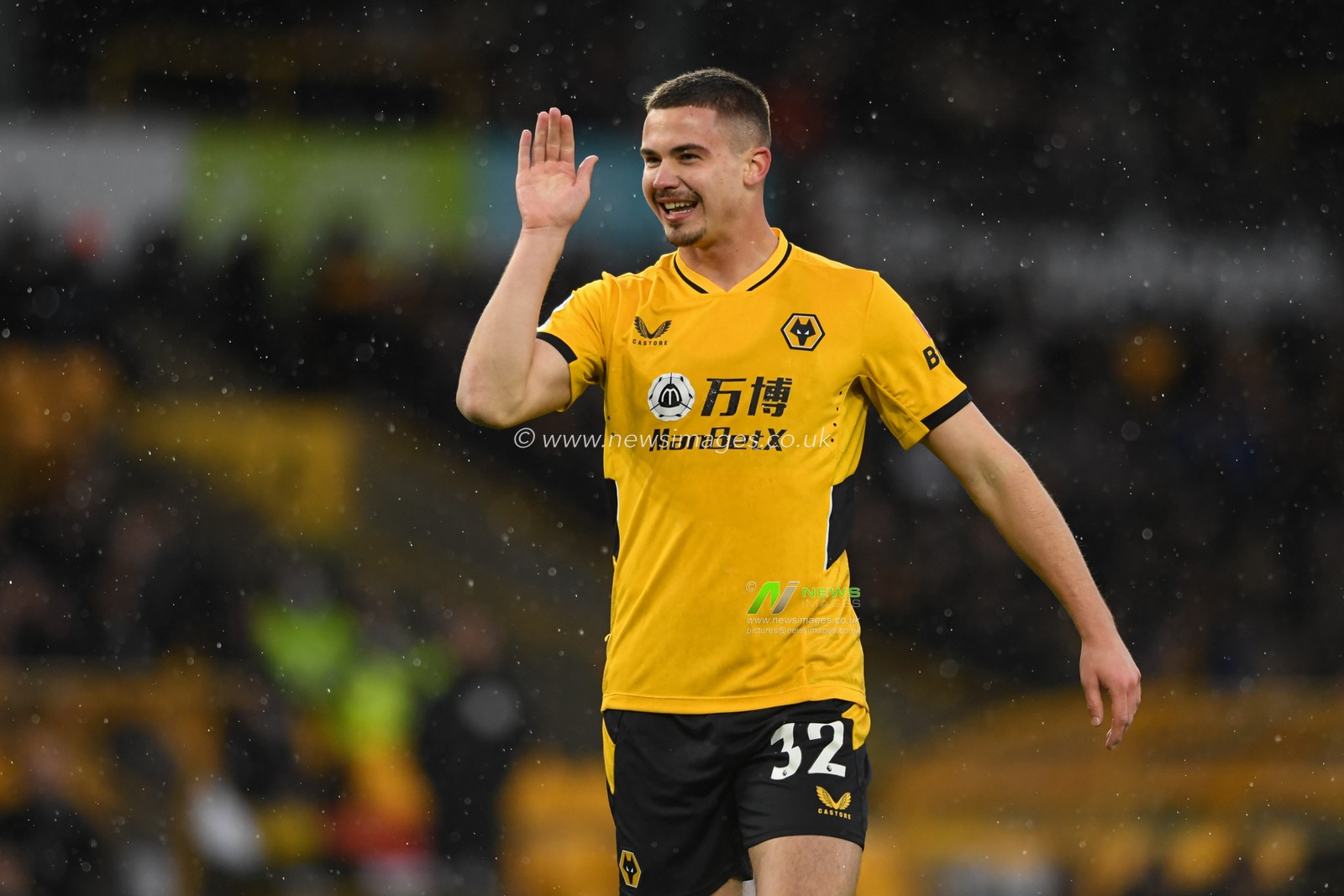 Leander Dendoncker #32 of Wolverhampton Wanderers jokes with his team mates during the game