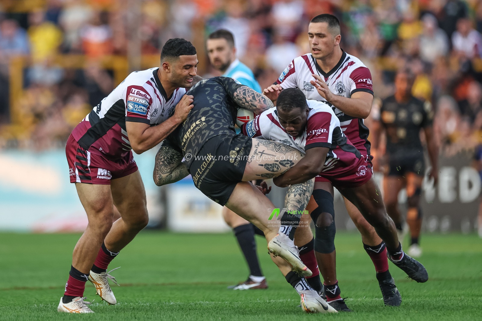 Josh Charnley of Leigh Leopards is tackled by Muizz Mustapha of Castleford Tigers during the Betfred Super League Round 20 match Castleford Tigers vs Leigh Leopards at The Mend-A-Hose Jungle, Castleford, United Kingdom, 1st August 2024

(Photo by Mark Cosgrove/News Images)