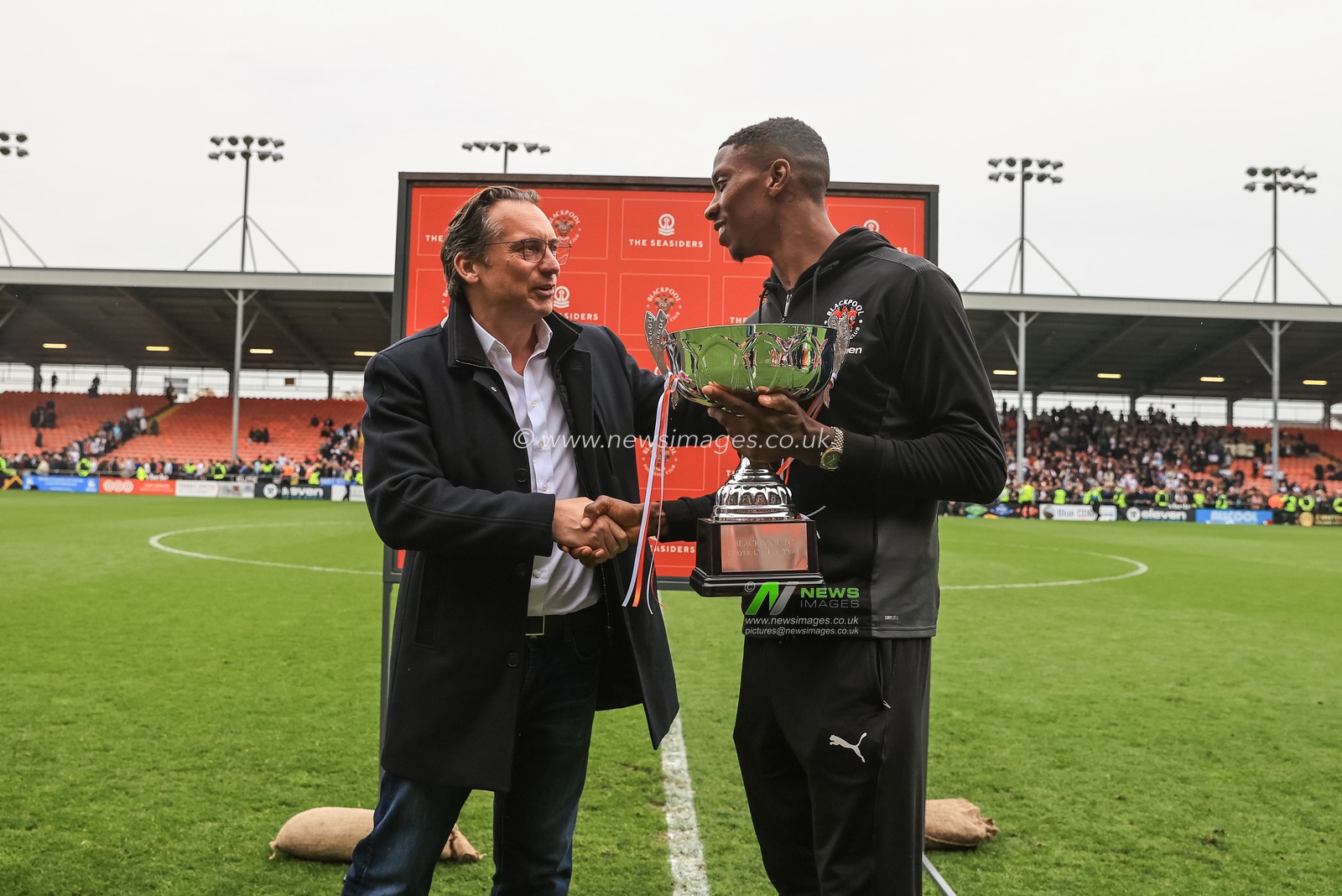 Simon Sadler owner of Blackpool presents the player of the year trophy to Marvin Ekpiteta #21 of Blackpool