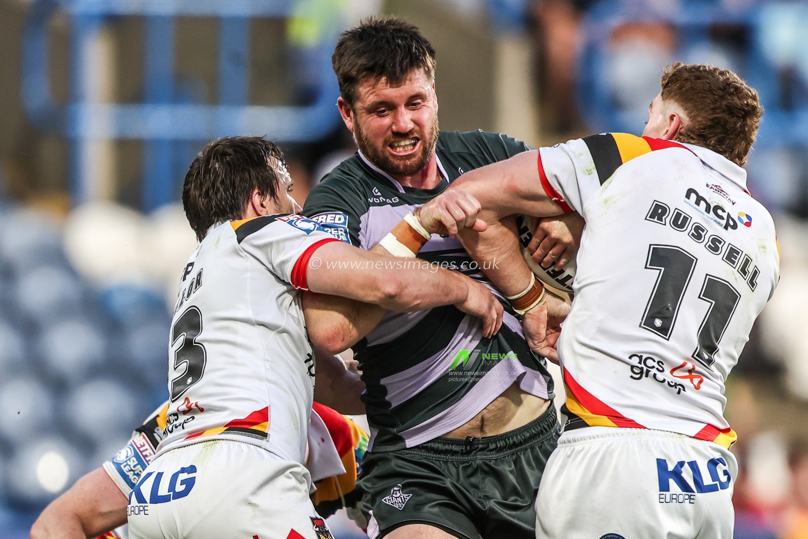 Joe Greenwood of Huddersfield Giants is tackled by Joe Mellor of Bradford Bulls and Dan Russell of Bradford Bulls during the Betfred Super League round 18 match Huddersfield Giants vs Bradford Bulls at Accu Stadium, Huddersfield, United Kingdom on 10 July 2026

(Photo by Alfie Cosgrove/News Images)