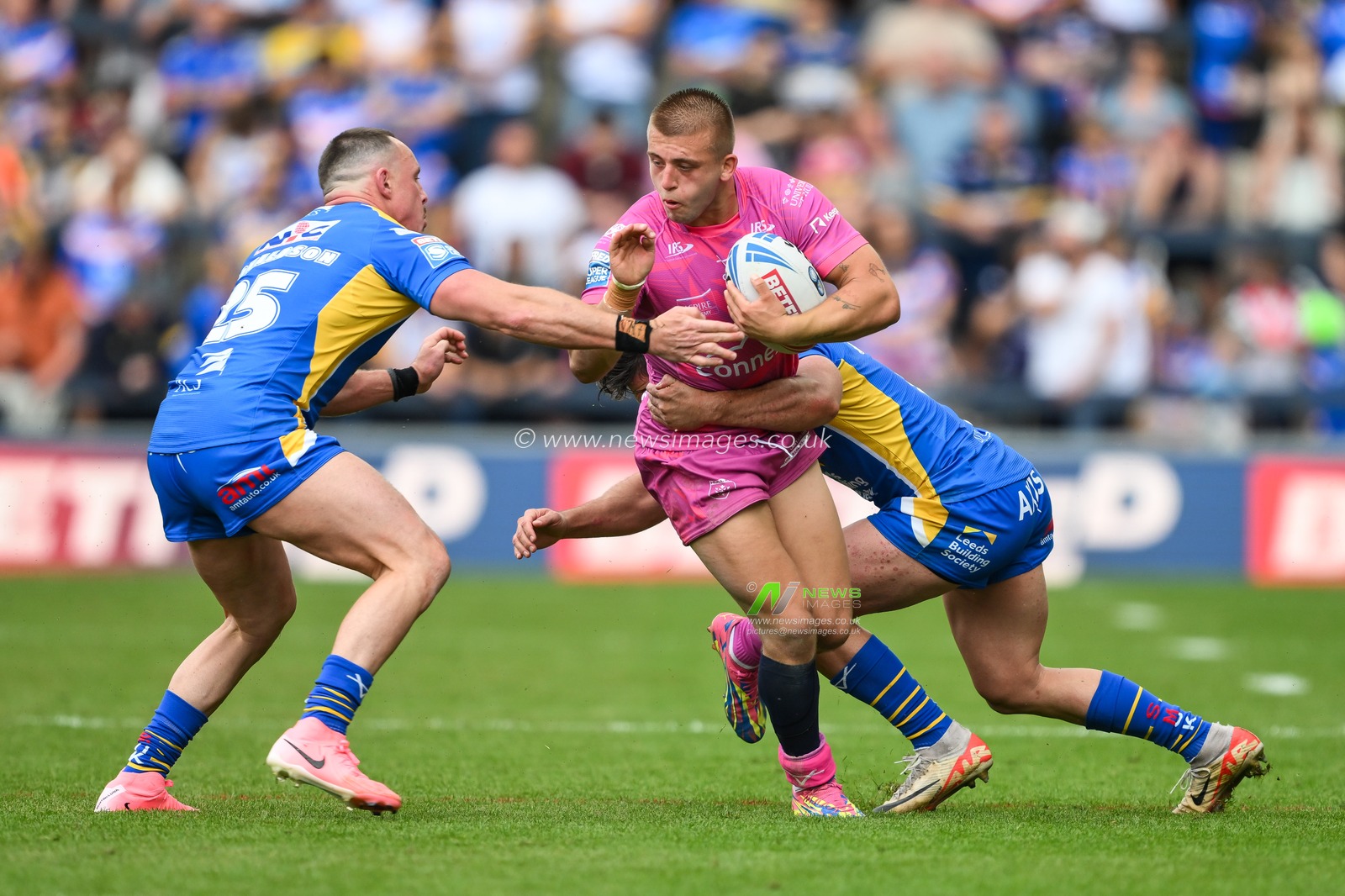 Mikey Lewis of Hull KR is tackled by Brodie Croft of Leeds Rhinos and James Donaldson of Leeds Rhinos during the Betfred Super League Round 18 match Leeds Rhinos vs Hull KR at Headingley Stadium, Leeds, United Kingdom, 20th July 2024

(Photo by Craig Thomas/News Images)