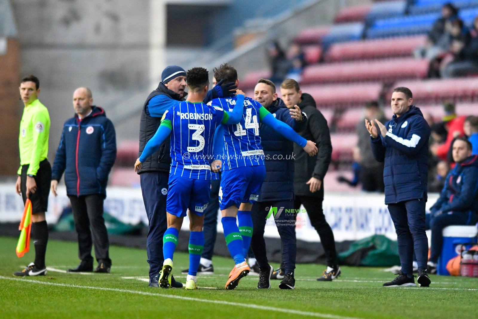 30th November 2019, DW Stadium, Wigan, England; Sky Bet Championship, Wigan Athletic v Reading : Joe Garner (14) of Wigan Athletic celebrates his goal with the management team to make it 1-0

Credit: Simon Whitehead/News Images