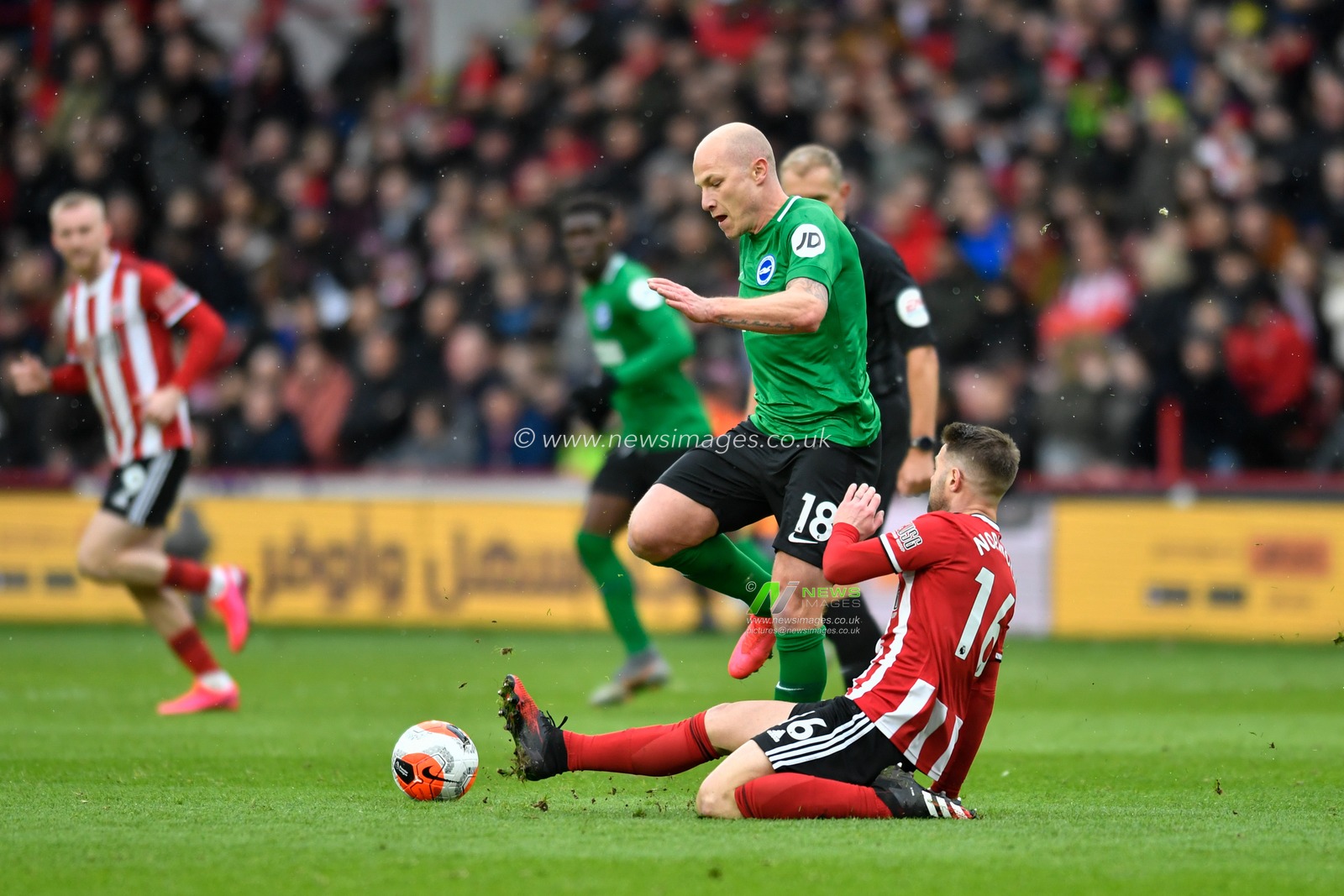 22nd February 2020, Bramall Lane, Sheffield, England; Premier League, Sheffield United v Brighton and Hove Albion : Aaron Mooy (18) of Brighton and Hove Albion is tackled by Oliver Norwood (16) of Sheffield United