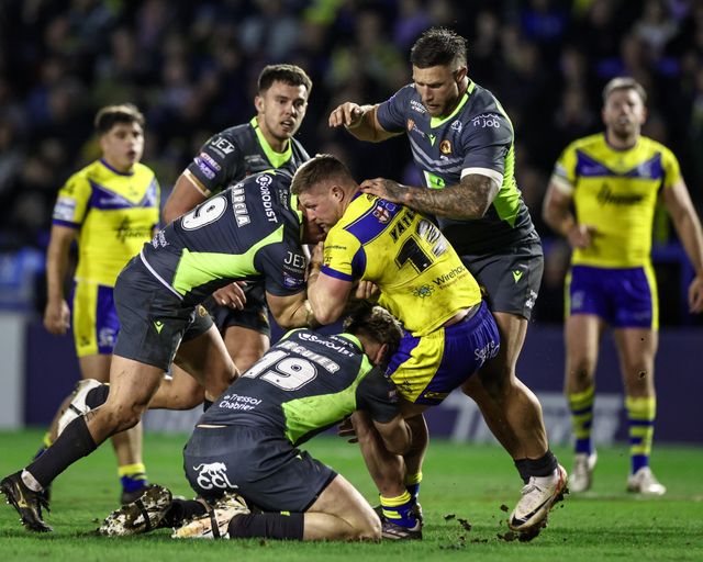 Luke Yates of Warrington Wolves is tackled by Benjamin Garcia of Catalan Dragons and Paul SÃ©guier of Catalan Dragons during the Betfred Super League Round 2 match Warrington Wolves vs Catalans Dragons at Luke Littler Stadium, Warrington, United Kingdom, 21st February 2025

(Photo by Mark Cosgrove/News Images)