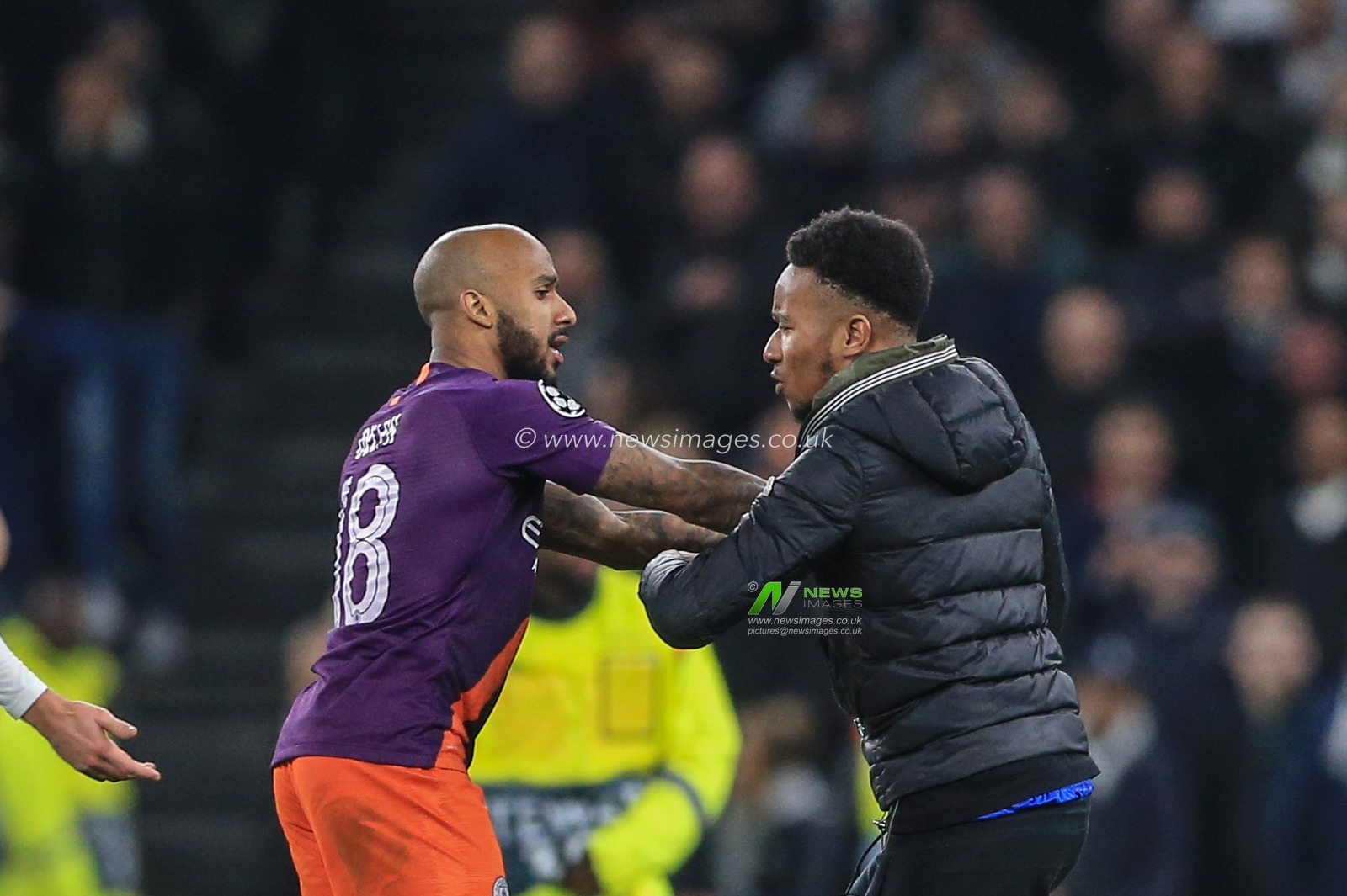 9th April 2019, Tottenham Hotspur Stadium, London, England ; UEFA Champions League, Quarter Final, Tottenham vs Manchester City ; Fabian Delph (18) of Manchester City holds off a Tottenham fan that runs on the pitch to him

Credit: Mark Cosgrove/News Images