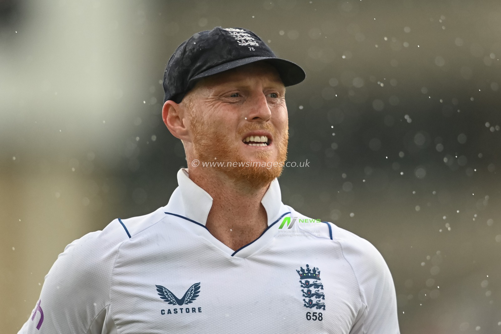 Ben Stokes of England leaves the field due to rain