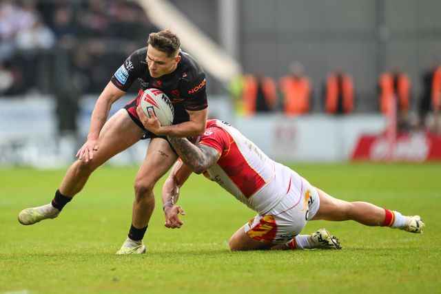 Jack Welsby of St. Helens is tackled by Tariq Sims of Catalan Dragons during the Betfred Super League Round 13 match St Helens vs Catalans Dragons at Totally Wicked Stadium, St Helens, United Kingdom, 31st May 2024

(Photo by Craig Thomas/News Images)