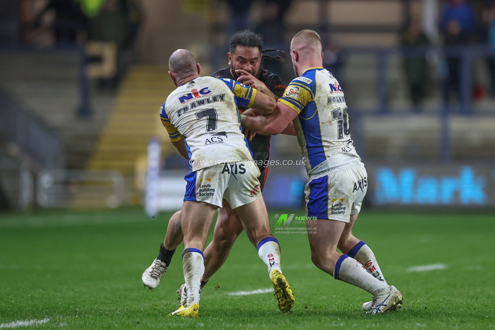 Konrad Hurrell of St. Helens is tackled by Matt Frawley of Leeds Rhinos and Tom Holroyd of Leeds Rhinos during the Betfred Challenge Cup Sixth Round match Leeds Rhinos vs St Helens at Headingley Stadium, Leeds, United Kingdom, 22nd March 2024

(Photo by Mark Cosgrove/News Images)