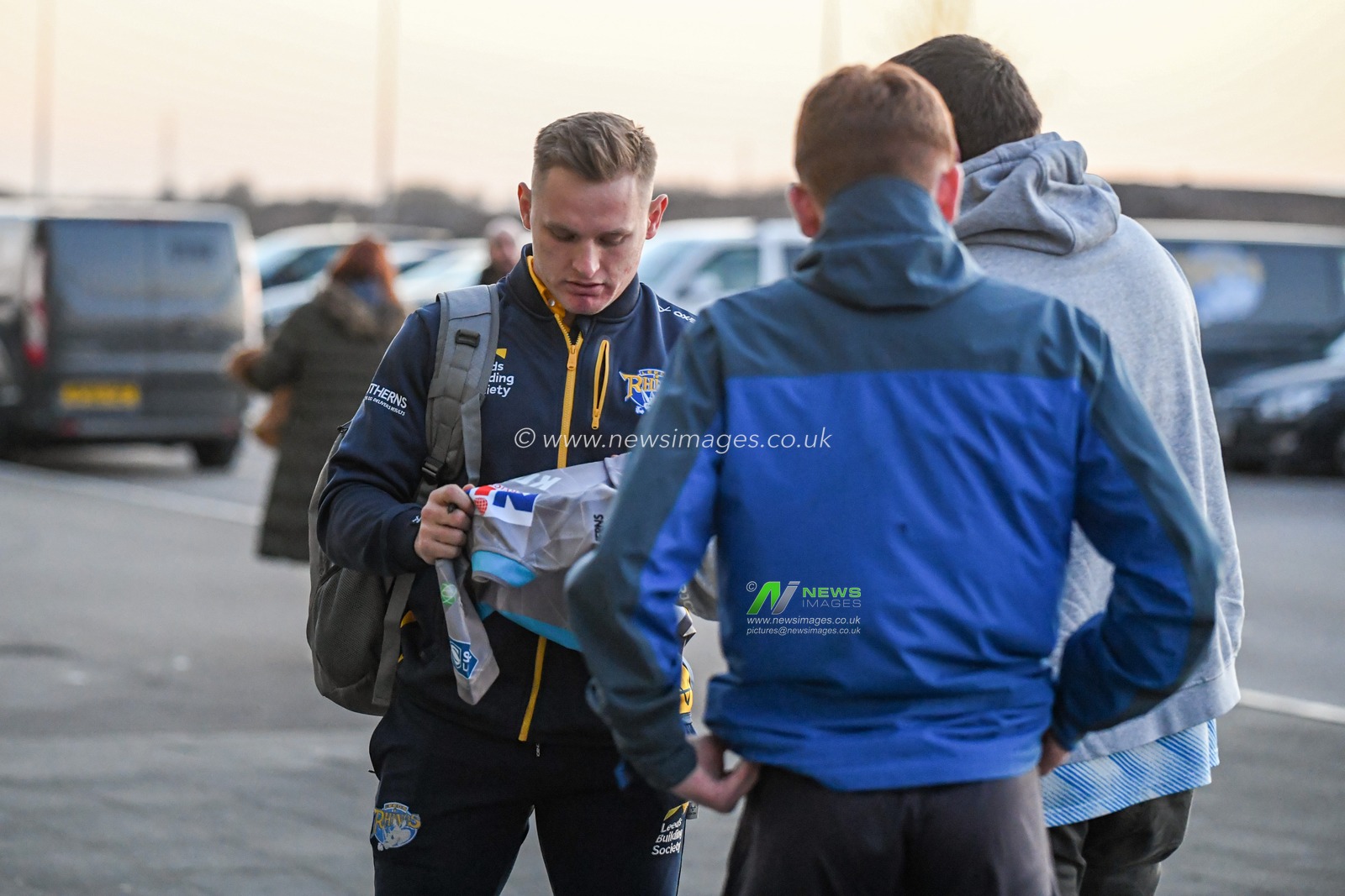 Brad Dwyer #14 of Leeds Rhinos signs autographs as he arrives at the AJ Bell Stadium for the game against Salford Red Devils