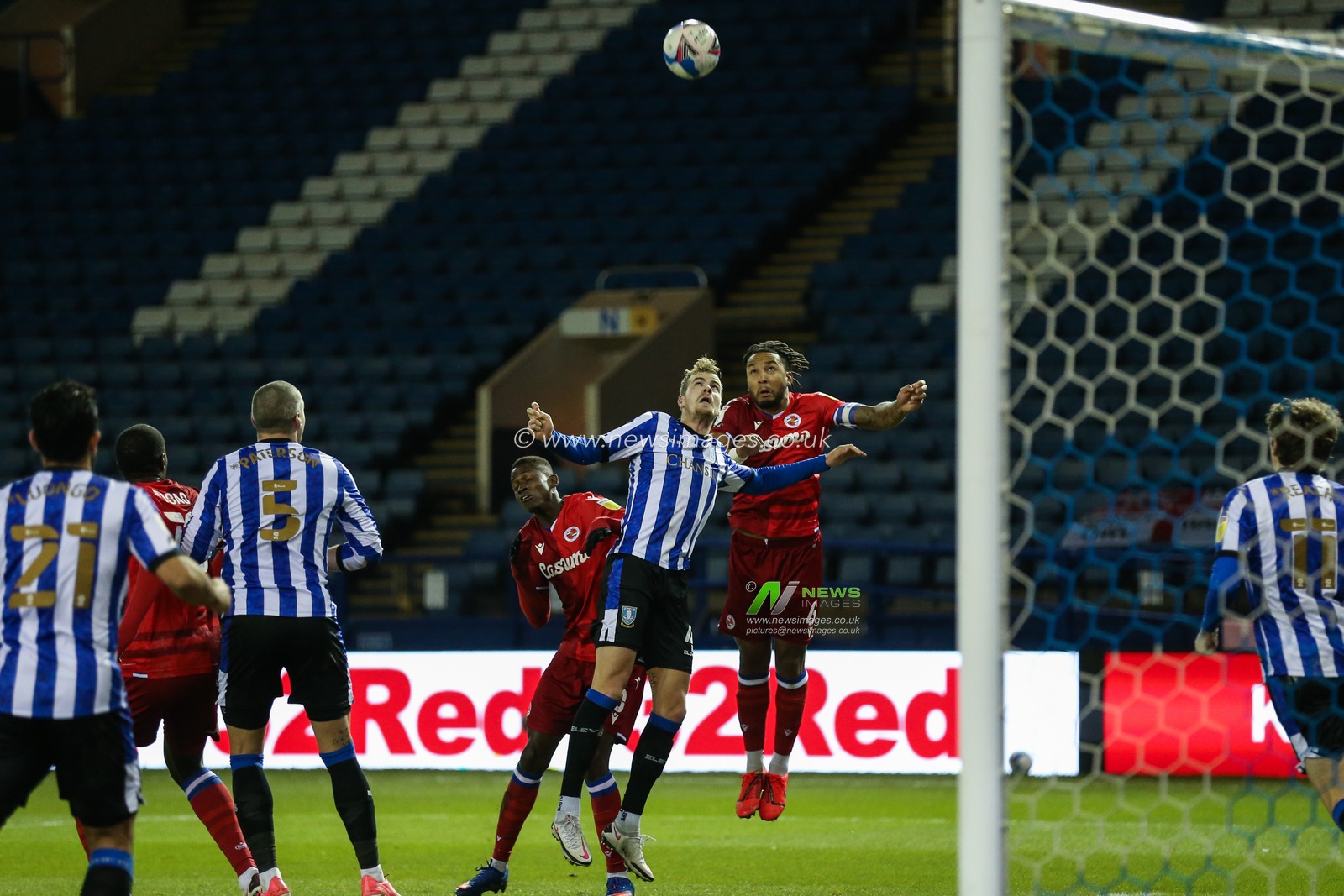 Joost van Aken #4 of Sheffield Wednesday and Liam Moore #6 of Reading dump up for a header