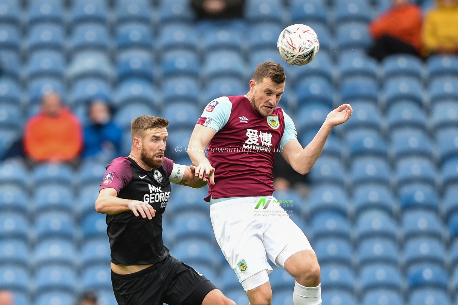 4th January 2020, Turf Moor, Burnley, England; Emirates FA Cup, Burnley v Peterborough : Chris Wood (9) of Burnley and Mark Beevers (5) of Peterborough United challenges for the high ball.

Credit: Richard Long/News Images