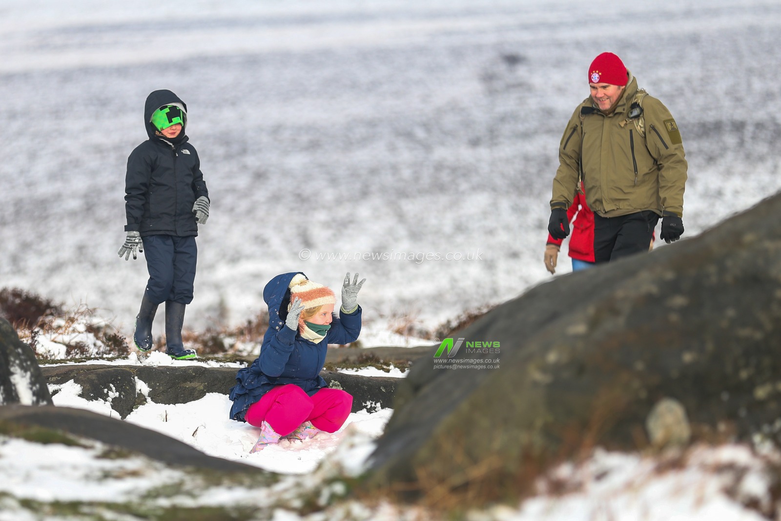 Family enjoy a walk as heavy snow falls in the Peak District