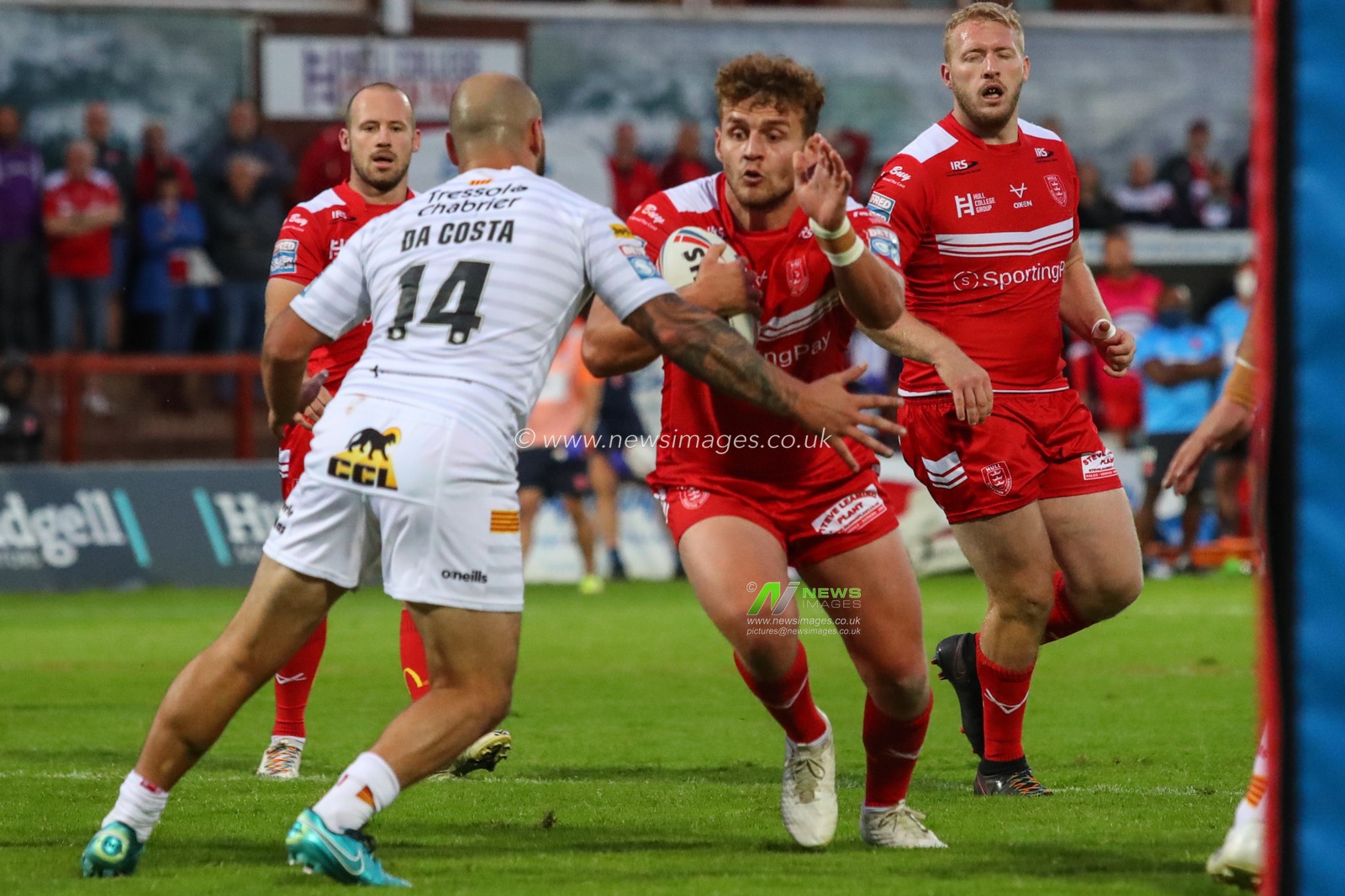 George Lawler (15) of Hull KR runs at Alrix Da Costa (14) of Catalans Dragons