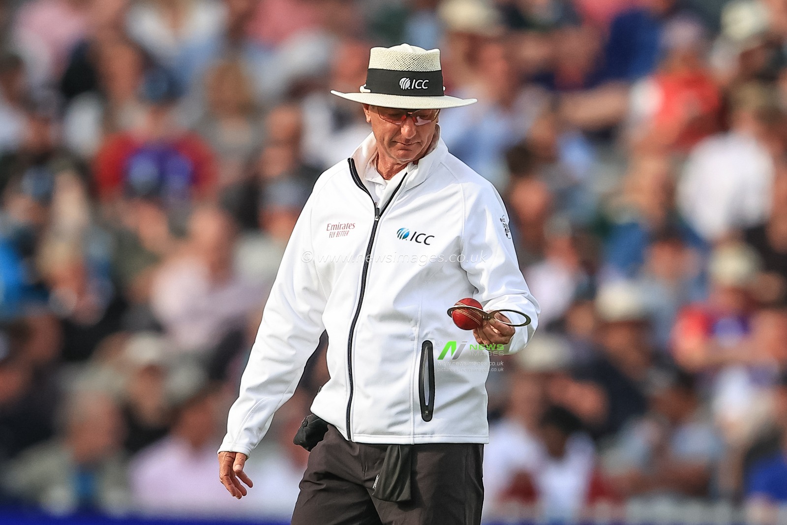 Umpire Rod Tucker checks the ball before offering England a new ball