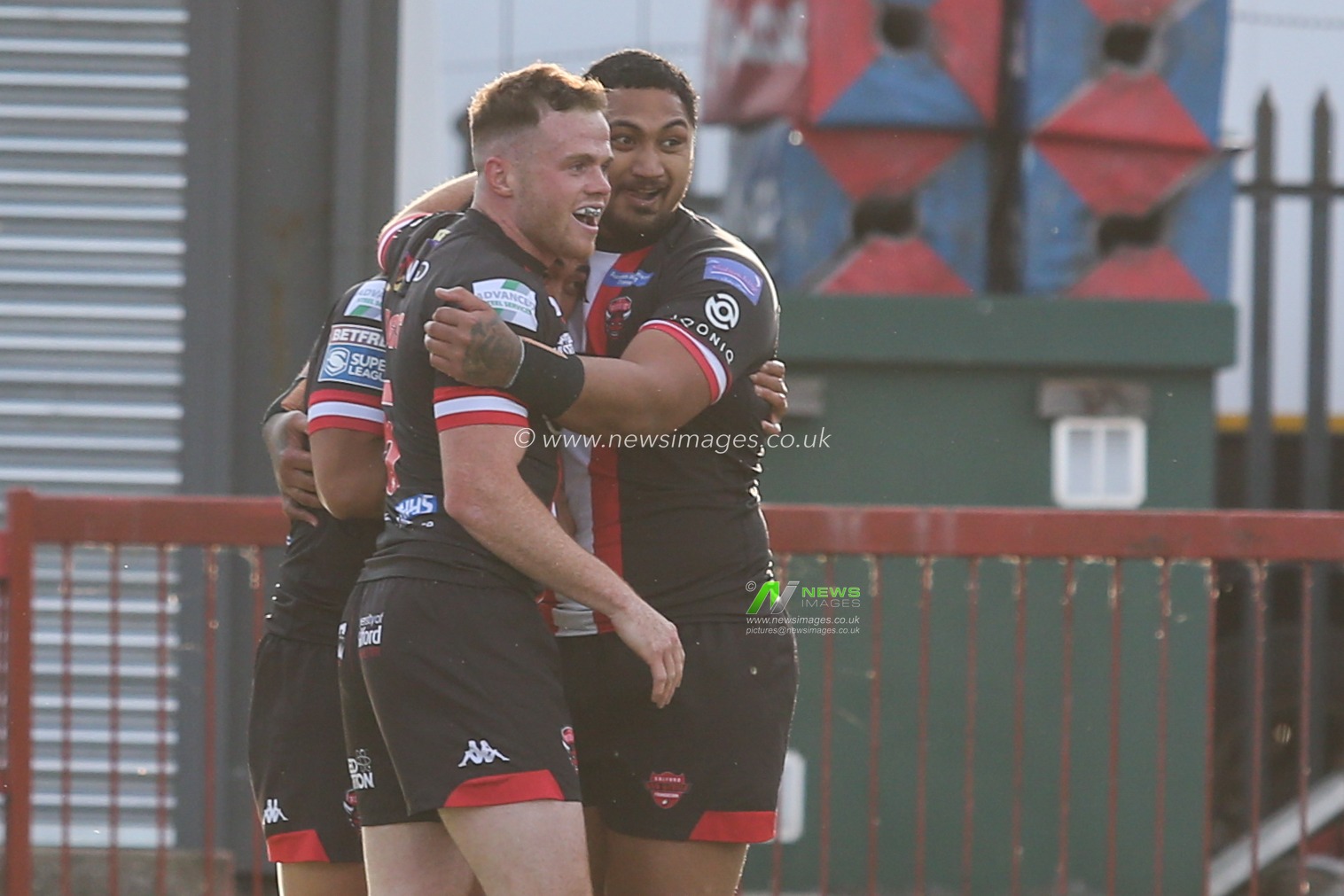 Ken Sio (2) of Salford Red Devils celebrates his try with Joe Burgess (5) and Pauli Pauli (12) of Salford Red Devils