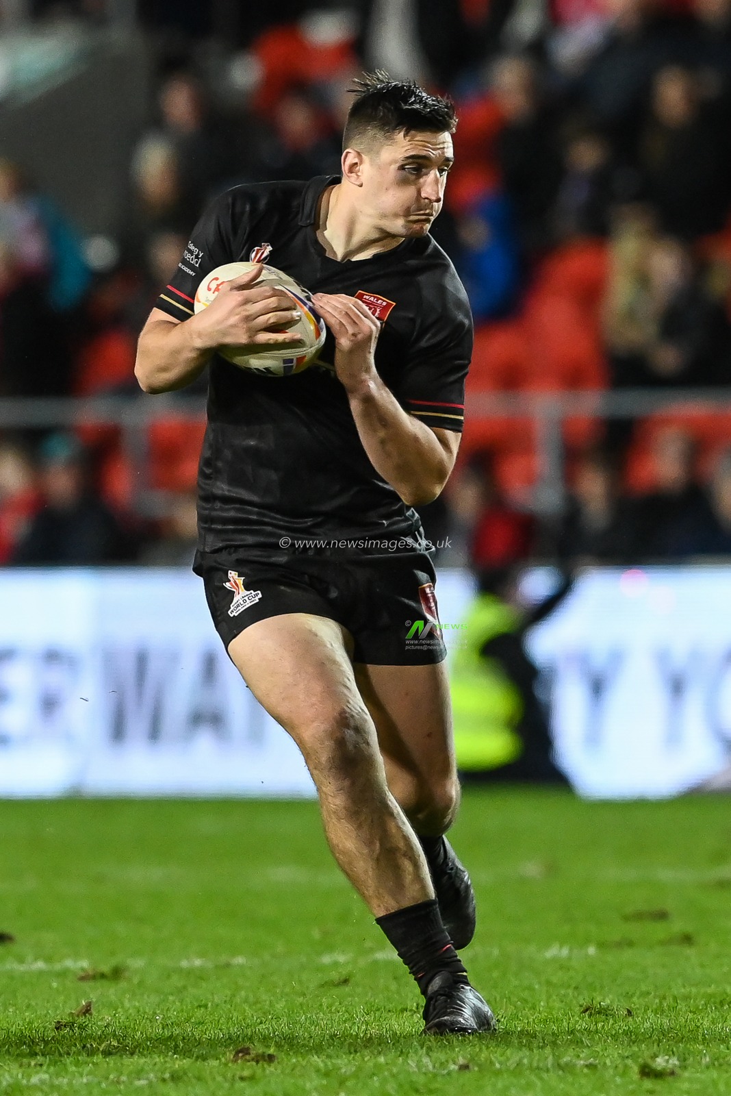 Joe Burke of Wales makes a break during the Rugby League World Cup 2021 match Tonga vs Wales at Totally Wicked Stadium, St Helens, United Kingdom, 24th October 2022

(Photo by Craig Thomas/News Images)