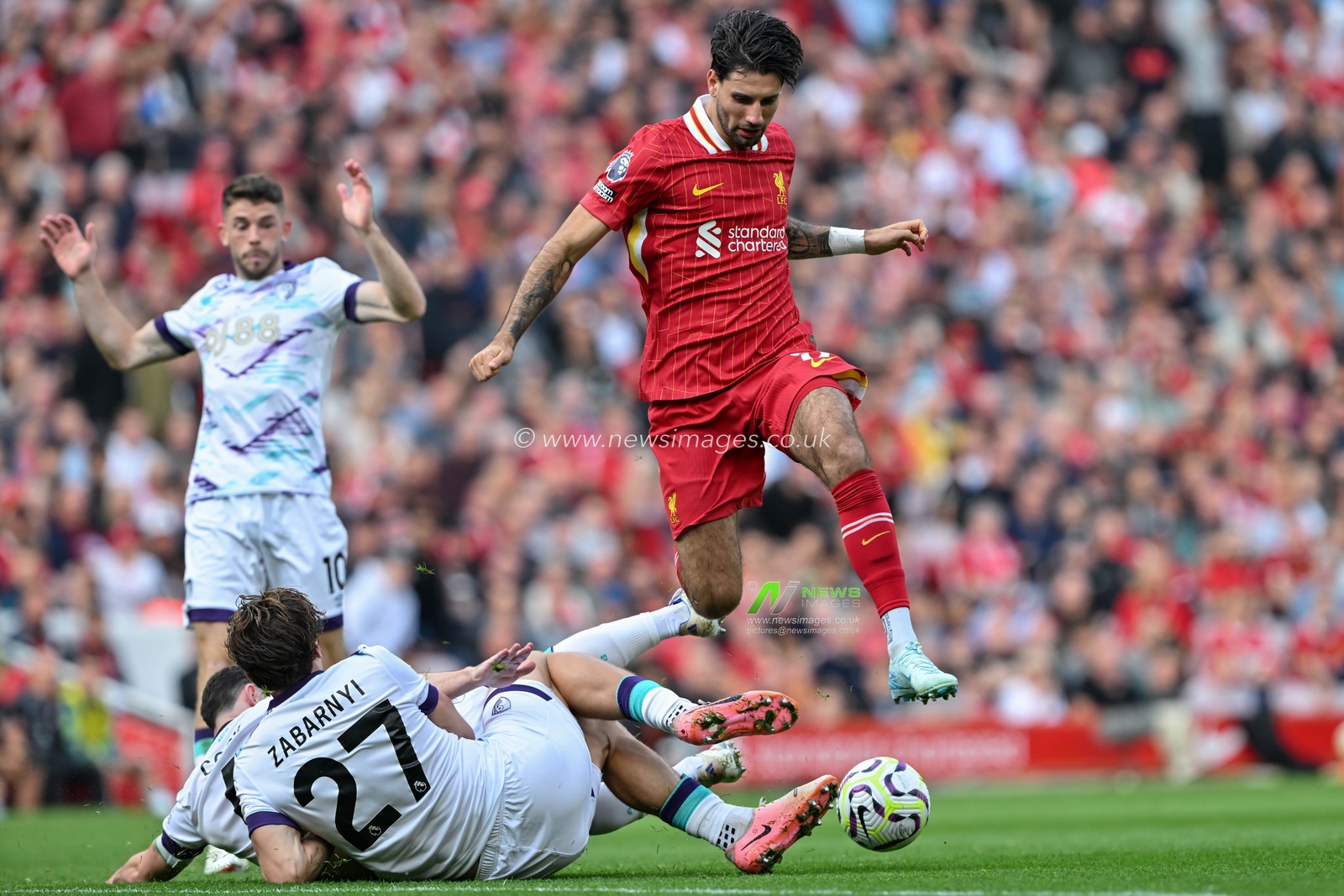 Illya Zabarnyi of Bournemouth tackles Dominik Szoboszlai of Liverpool during the Premier League match Liverpool vs Bournemouth at Anfield, Liverpool, United Kingdom, 21st September 2024

(Photo by Cody Froggatt/News Images)