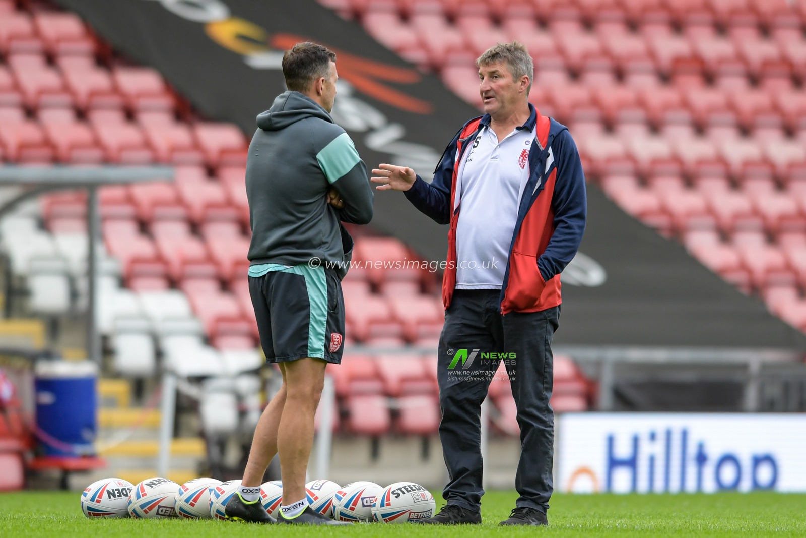 Tony Smith Head Coach of Hull KR speaks with Danny McGuire assistant coach of Hull KR before the game