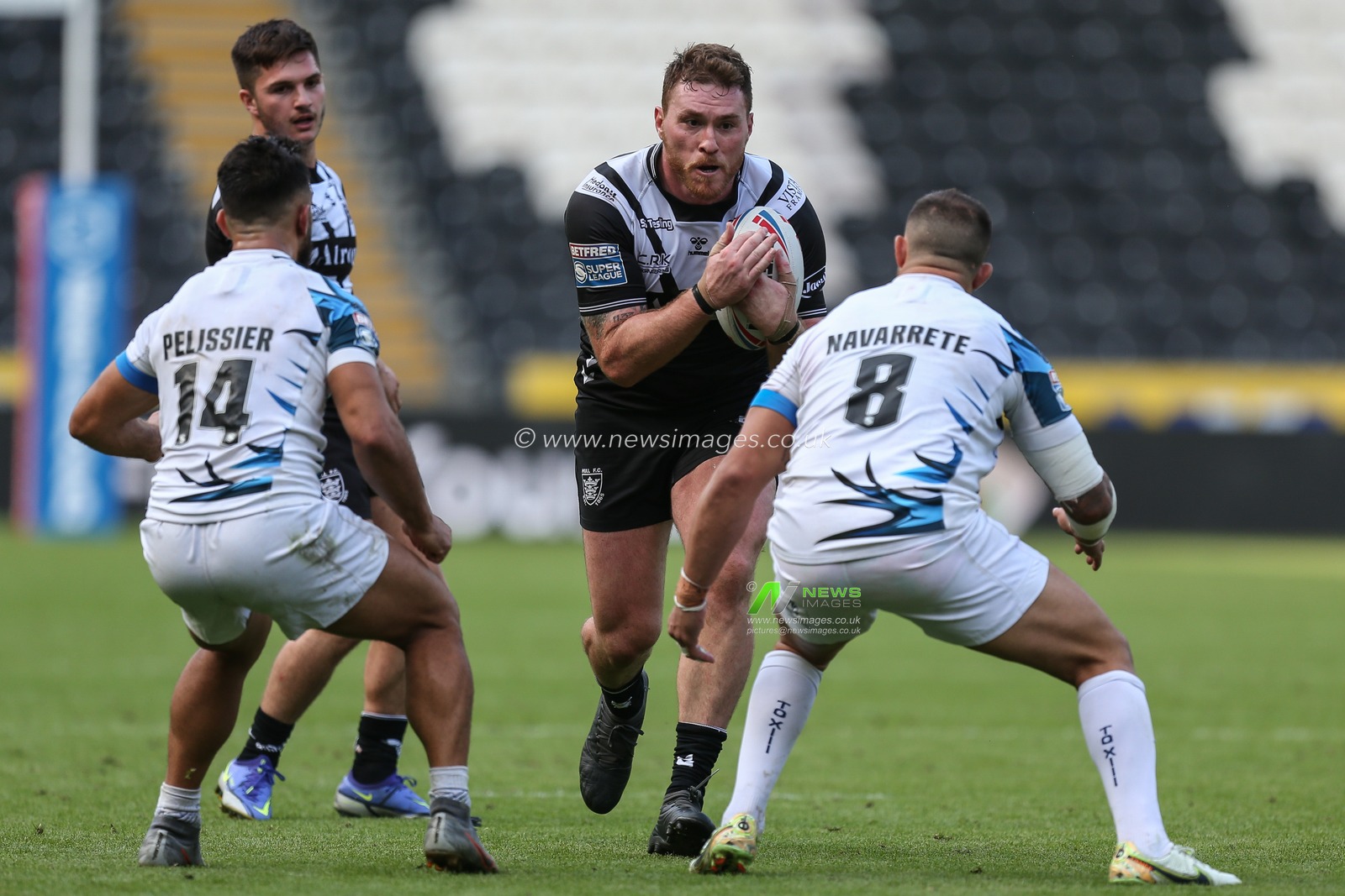 Scott Taylor #30 of Hull FC runs at Romain Navarrete #8 of Toulouse Olympique
