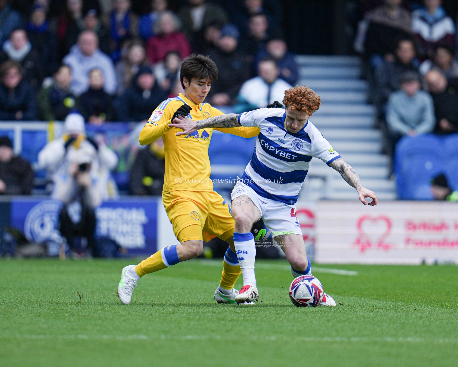Ao Tanaka of Leeds United puts Jack Colback of Queens Park Rangers under pressure during the Sky Bet Championship match Queens Park Rangers vs Leeds United at Kiyan Prince Foundation Stadium, London, United Kingdom, 15th March 2025

(Photo by Harvey Murphy/News Images)