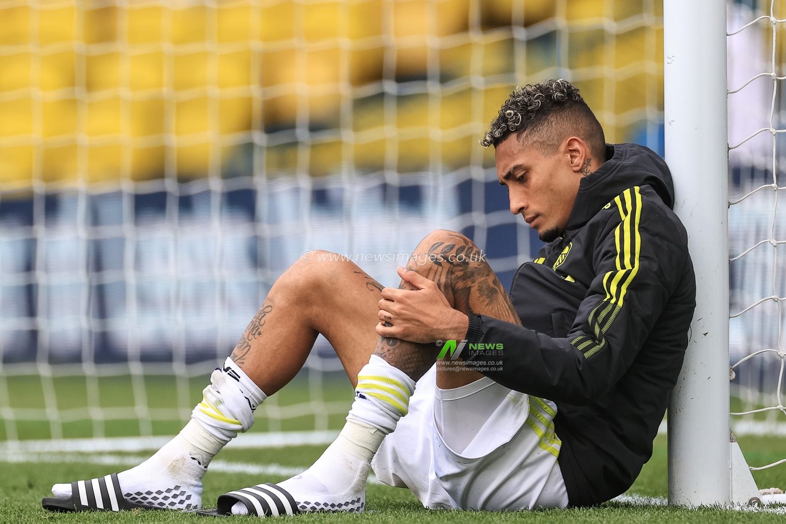 Raphinha #10 of Leeds United takes a minute to himself after the final whistle