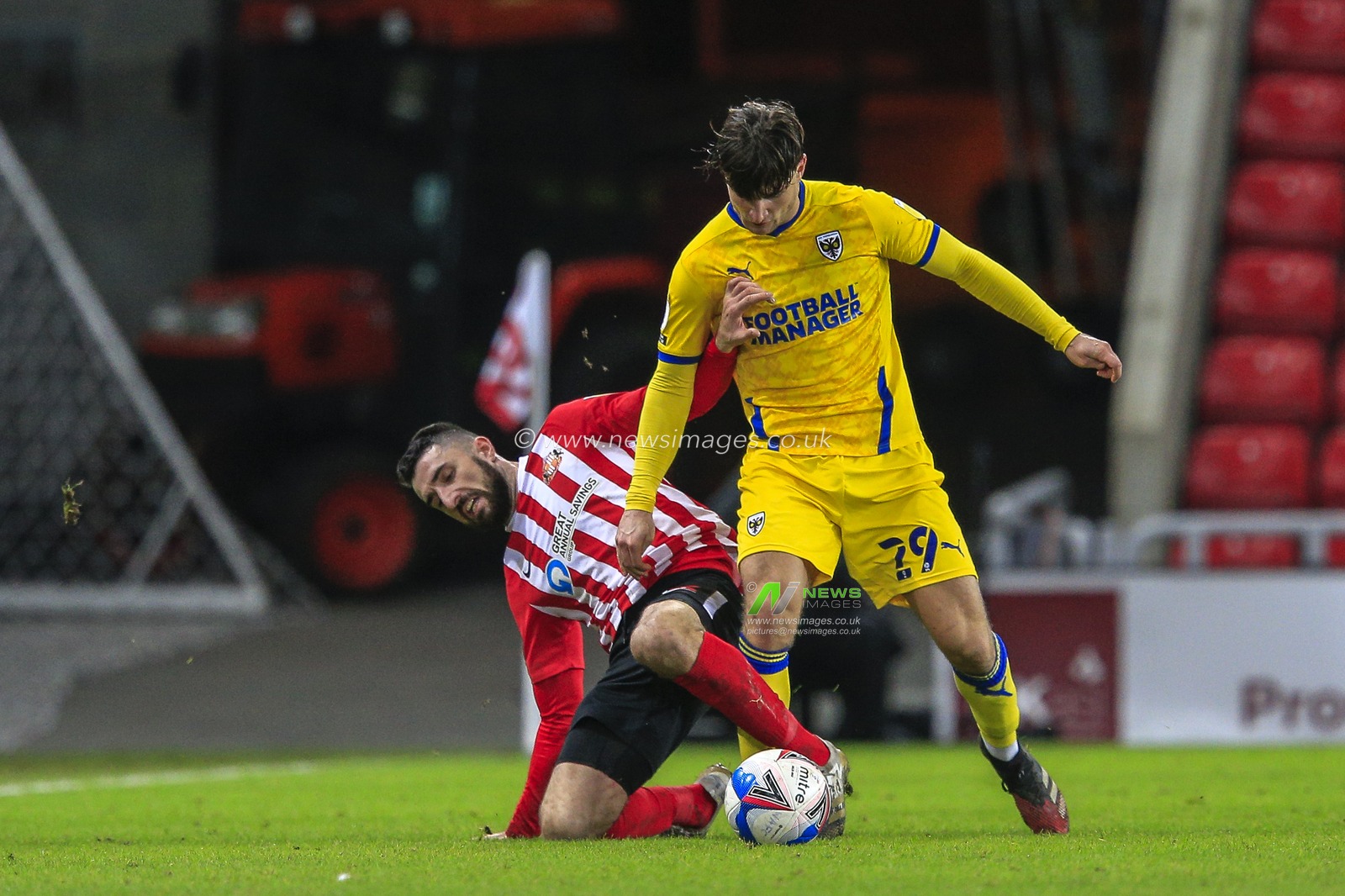 Conor McLaughlin #2 of Sunderland tries to take the ball from Ryan Longman #29 of AFC Wimbledon