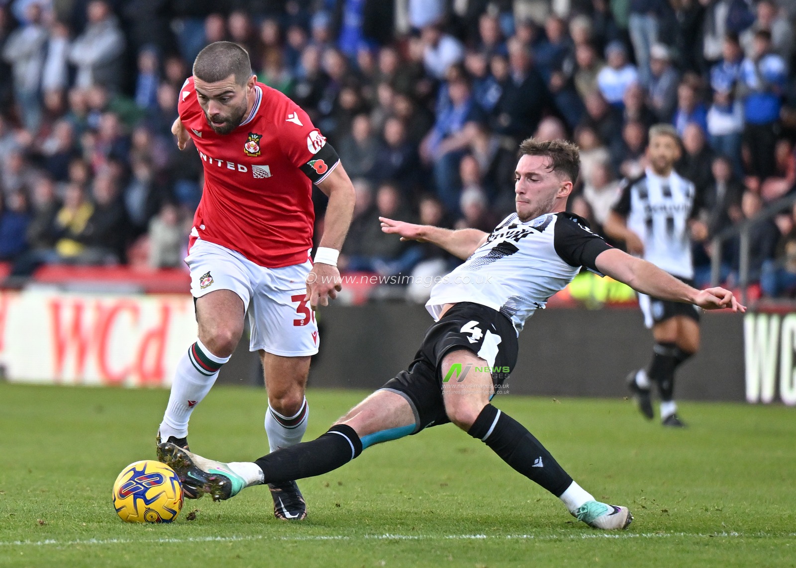 Elliot Lee 38# of Wrexham Association Football Club rides a challenge from Conor Masterson 4# of Gillingham Football Club, during the Sky Bet League 2 match Wrexham vs Gillingham at SToK Cae Ras, Wrexham, United Kingdom, 11th November 2023

(Photo by Cody Froggatt/News Images)