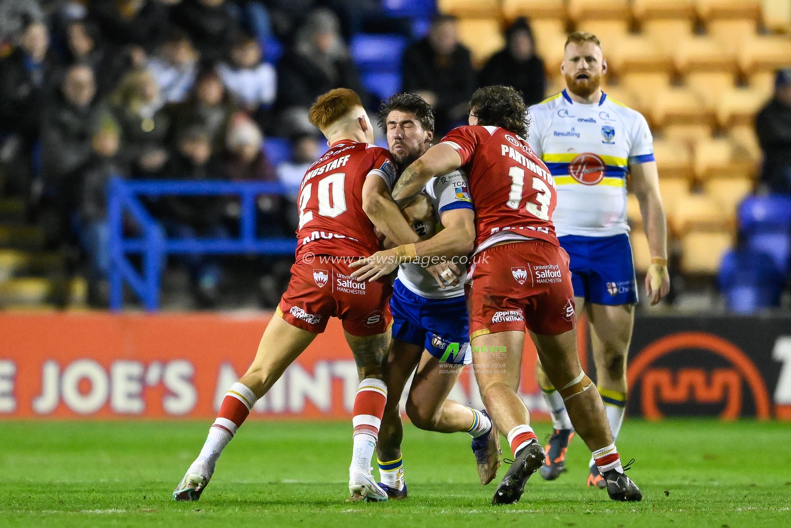 Greg Minikin #21 of Warrington Wolves is tackled by Ellis Longstaff #20 of Salford Red Devils during the Betfred Super League Round 3 match Warrington Wolves vs Salford Red Devils at Halliwell Jones Stadium, Warrington, United Kingdom, 2nd March 2023

(Photo by Craig Thomas/News Images)