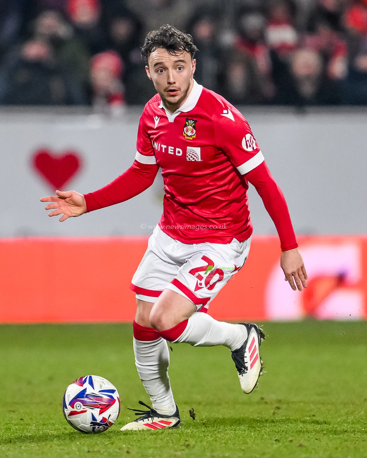 Ollie Rathbone of Wrexham makes a break with the ball during the Sky Bet League 1 match Wrexham vs Leyton Orient at SToK Cae Ras, Wrexham, United Kingdom, 18th February 2025

(Photo by Craig Thomas/News Images)
